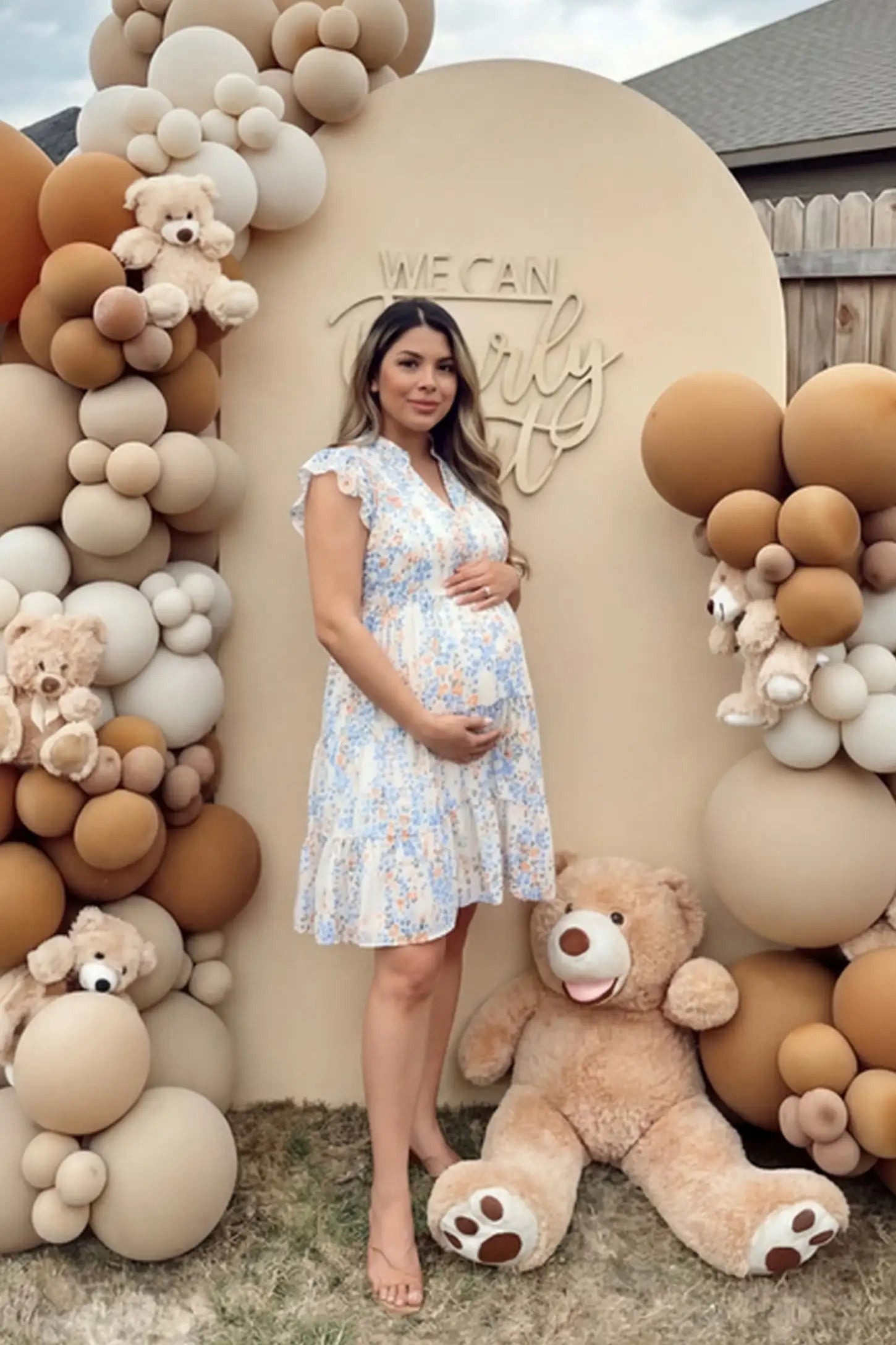 Floral V-neck A-line short maternity dress in white with airy chiffon flow, on editorial lifestyle model