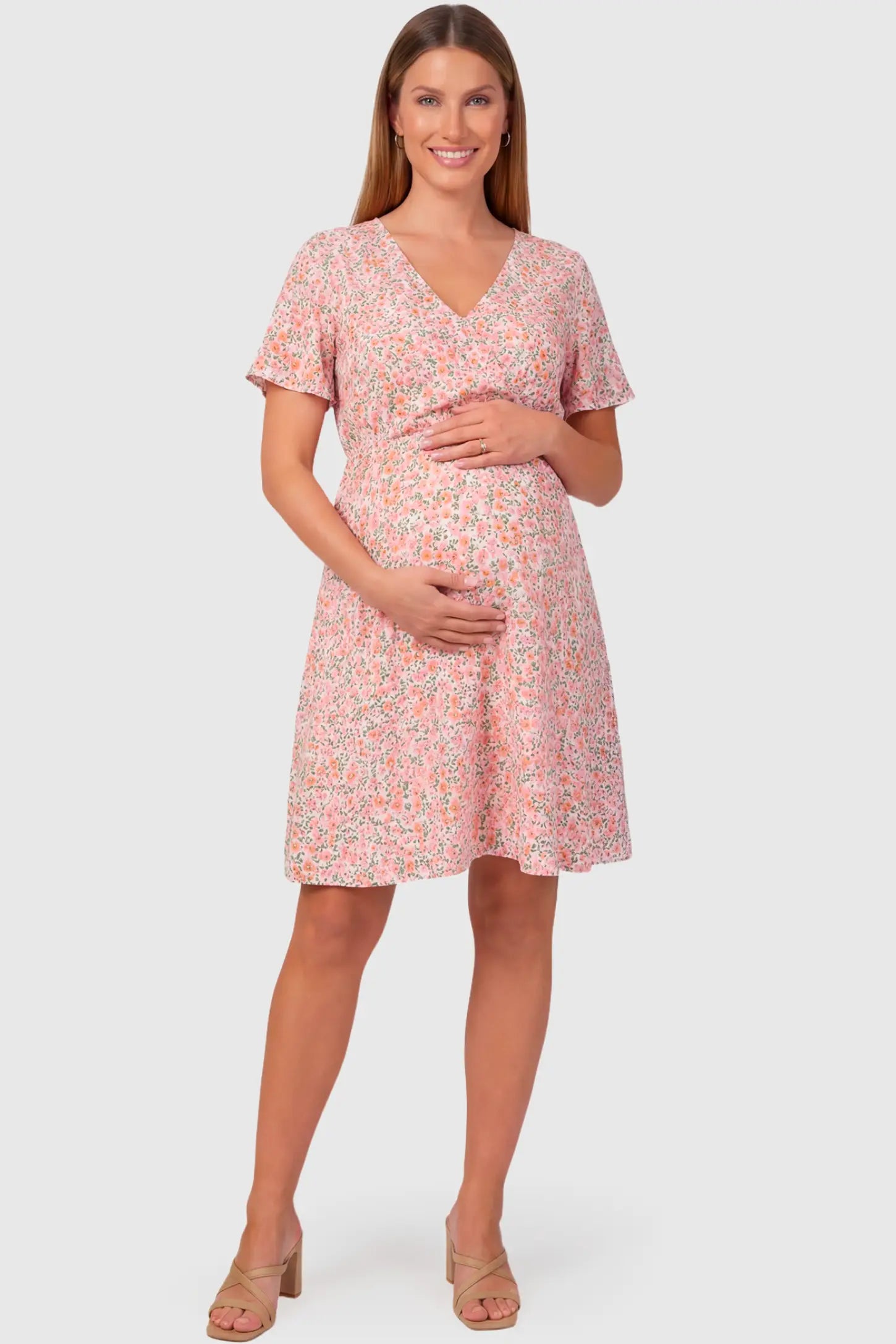 Short Sleeve A-Line Maternity Short Dress in pink floral featuring V-neck and empire waist on pregnant model.