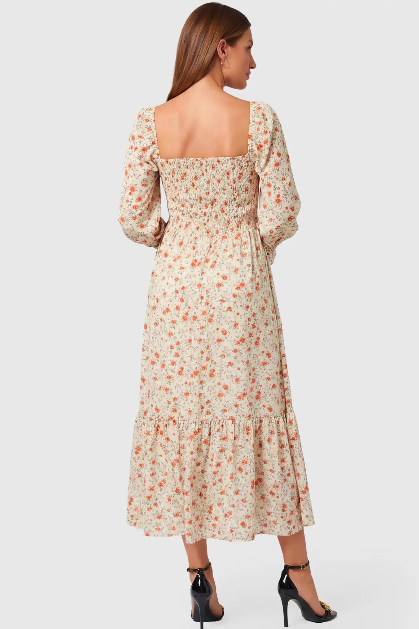 Floral Smocked Tiered Maternity Midi Dress Floral Smocked Tiered Maternity Midi Dress in white floral print featuring square neckline, puff sleeves, and tiered midi skirt on pregnant model, back view