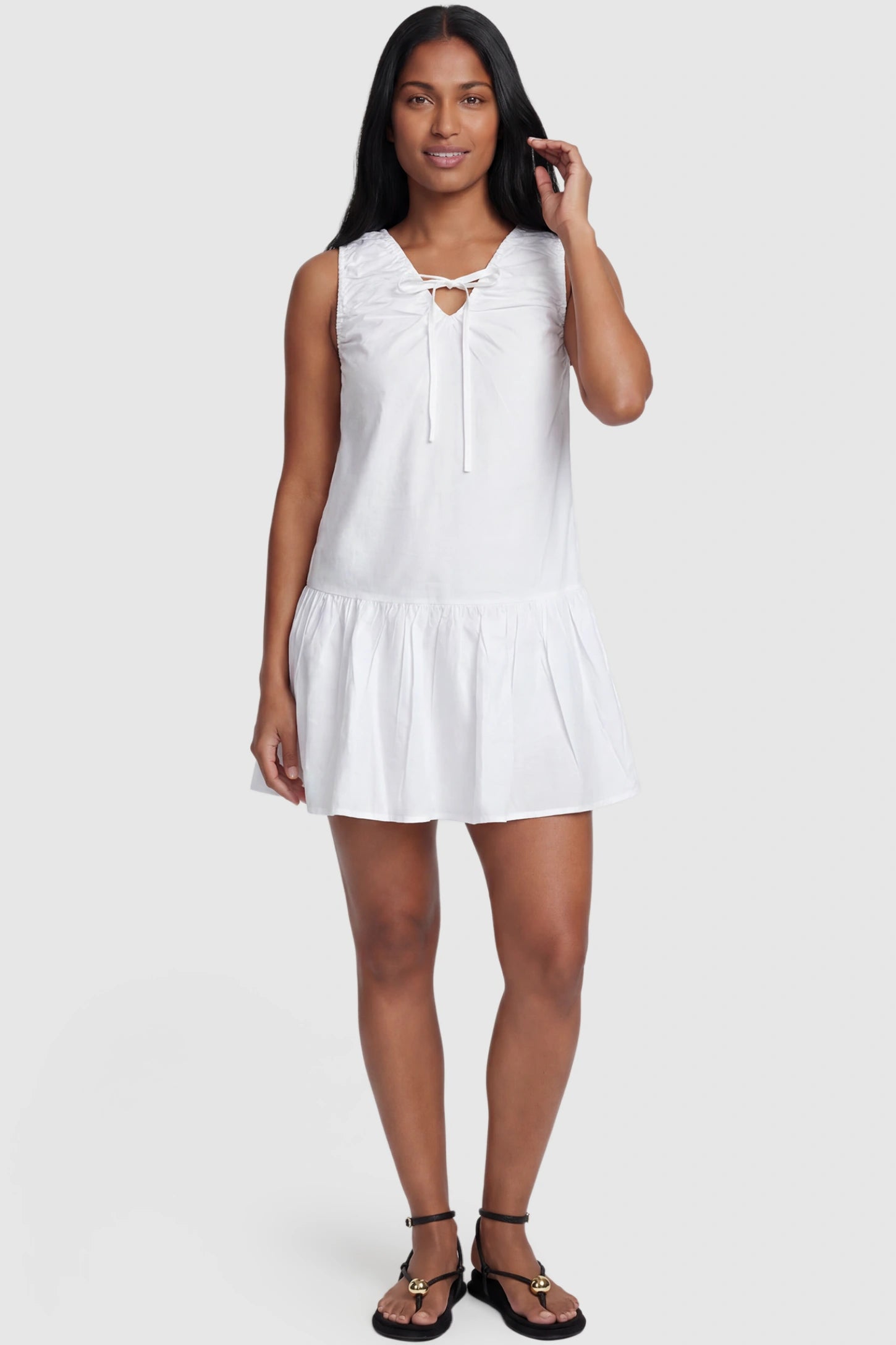 Keyhole Tie Sleeveless Maternity Short Dress Keyhole tie sleeveless maternity short dress in white with V-neckline and keyhole tie front detail, front view on postpartum model