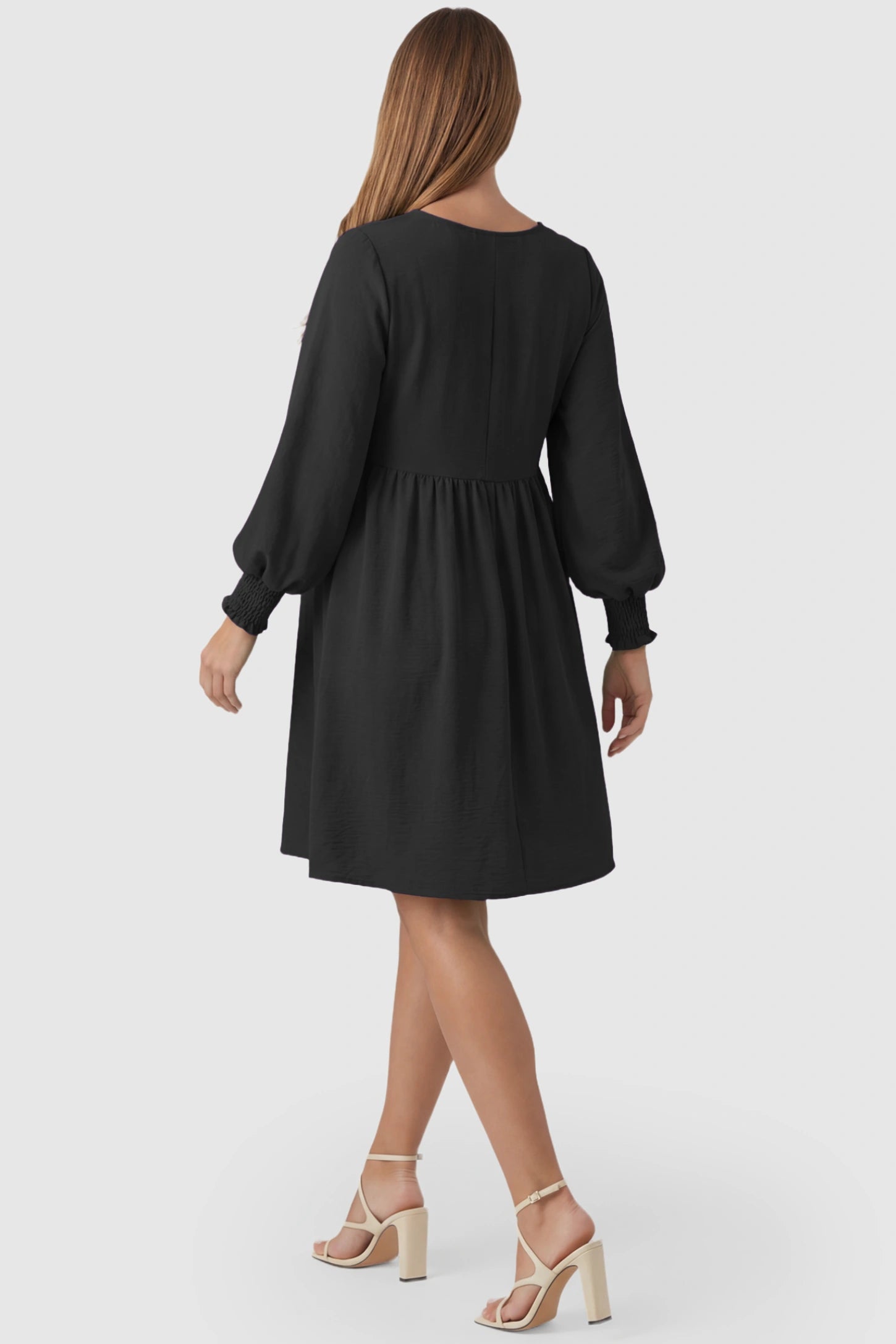 Balloon Sleeve Empire Waist Maternity Midi Dress Balloon Sleeve Empire Waist Maternity Midi Dress in black featuring smocked elastic cuff sleeves and soft drape on a pregnant model, back view.