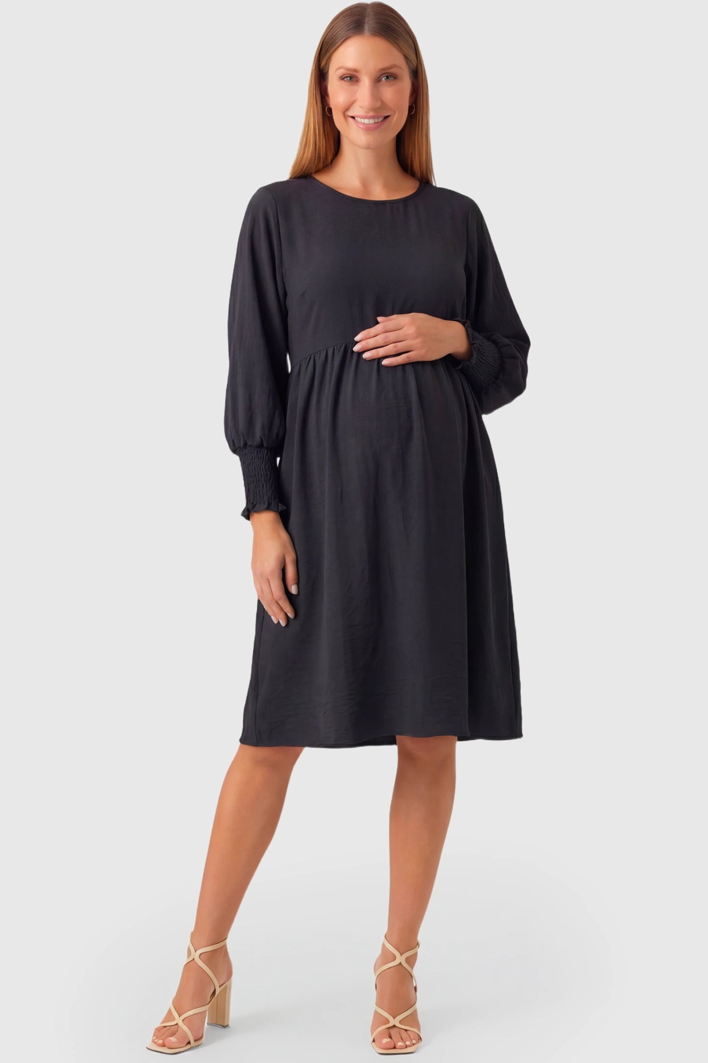 Balloon Sleeve Empire Waist Maternity Midi Dress Balloon Sleeve Empire Waist Maternity Midi Dress in black featuring smocked elastic cuff sleeves and soft drape on a pregnant model.