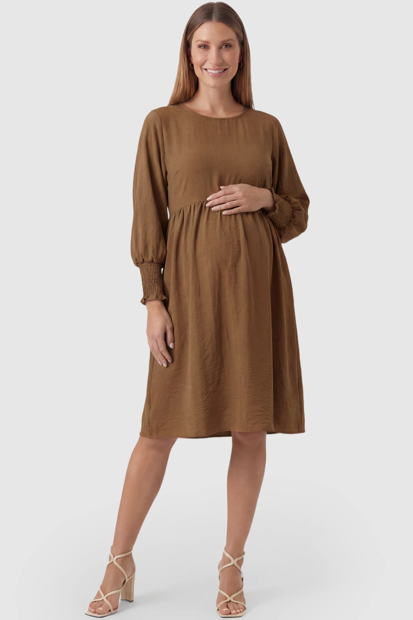 Balloon Sleeve Empire Waist Maternity Midi Dress Balloon Sleeve Empire Waist Maternity Midi Dress in dark brown featuring smocked elastic cuff sleeves and soft drape on a pregnant model, front view.