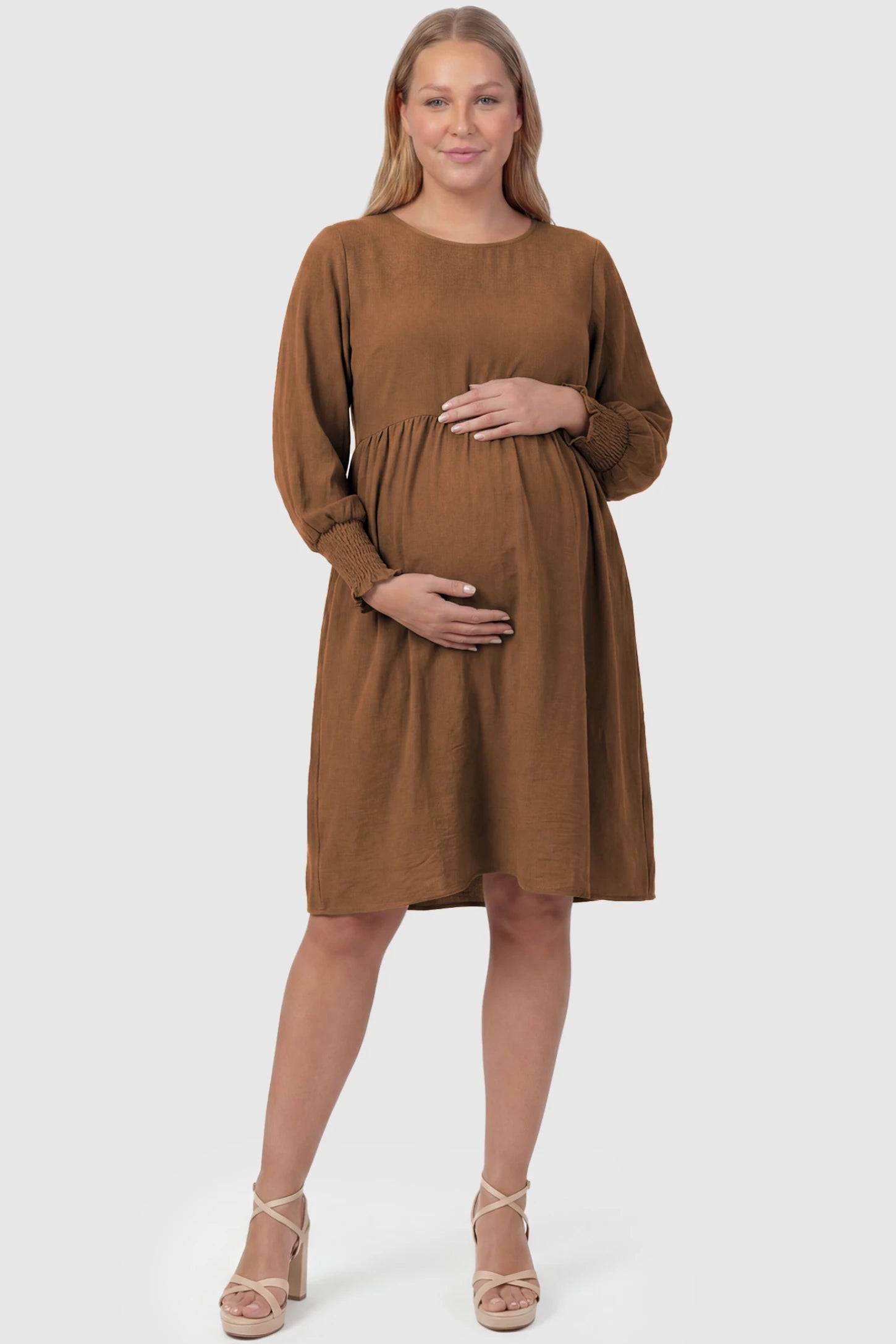 Balloon Sleeve Empire Waist Maternity Midi Dress Balloon Sleeve Empire Waist Maternity Midi Dress in dark brown featuring smocked elastic cuff sleeves and soft drape on a plus size pregnant model, front view.