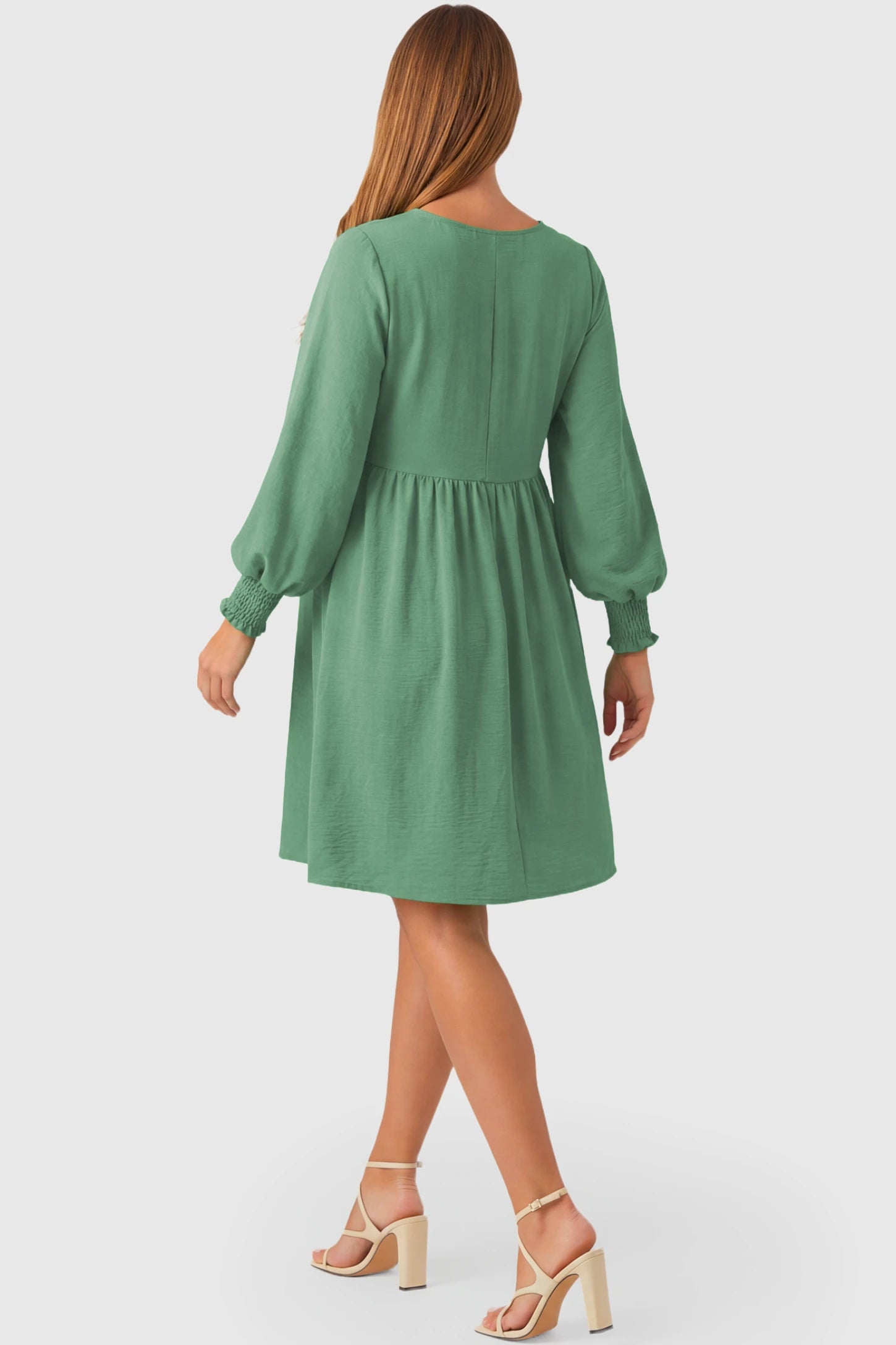 Balloon Sleeve Empire Waist Maternity Midi Dress Balloon Sleeve Empire Waist Maternity Midi Dress in emerald green featuring smocked elastic cuff sleeves and soft drape on a pregnant model.