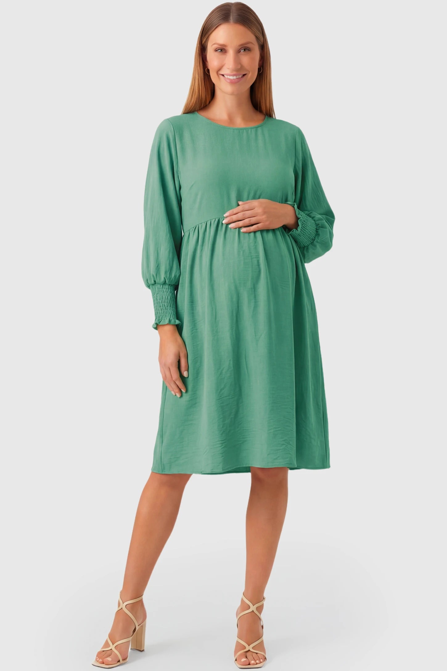 Balloon Sleeve Empire Waist Maternity Midi Dress Balloon Sleeve Empire Waist Maternity Midi Dress in emerald green featuring smocked elastic cuff sleeves and soft drape on a pregnant model.