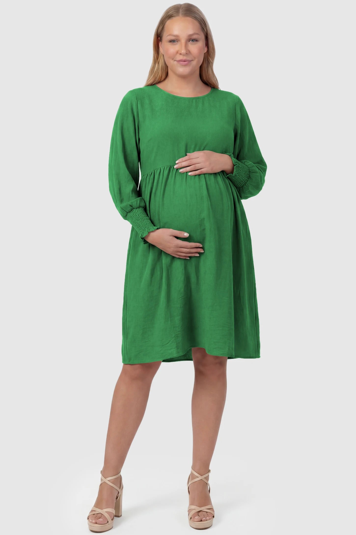 Balloon Sleeve Empire Waist Maternity Midi Dress Balloon Sleeve Empire Waist Maternity Midi Dress in green featuring smocked elastic cuff sleeves and soft drape on a plus size pregnant model, front view.