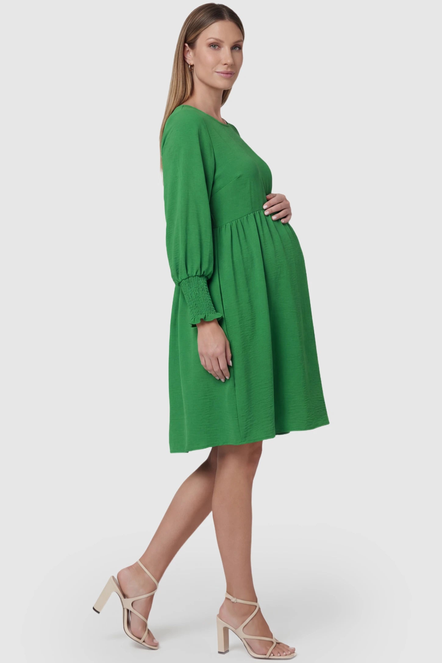 Balloon Sleeve Empire Waist Maternity Midi Dress Balloon Sleeve Empire Waist Maternity Midi Dress in green featuring smocked elastic cuff sleeves and soft drape on a pregnant model, side view.