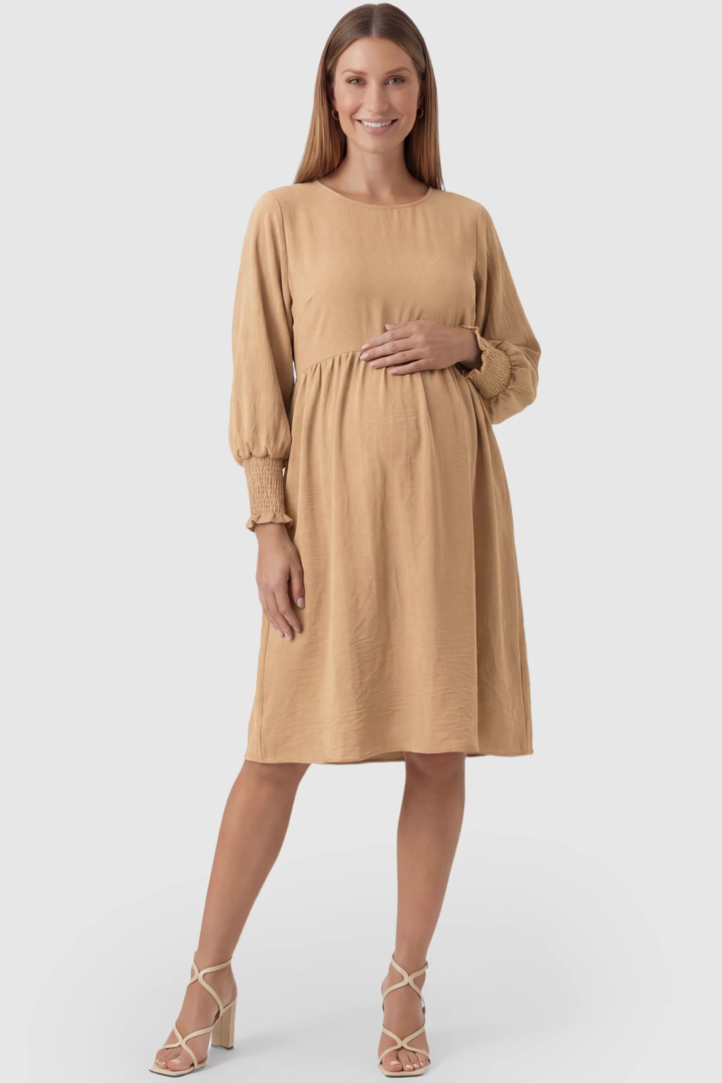 Balloon Sleeve Empire Waist Maternity Midi Dress Balloon Sleeve Empire Waist Maternity Midi Dress in khaki featuring smocked elastic cuff sleeves and soft drape on a pregnant model, front view.