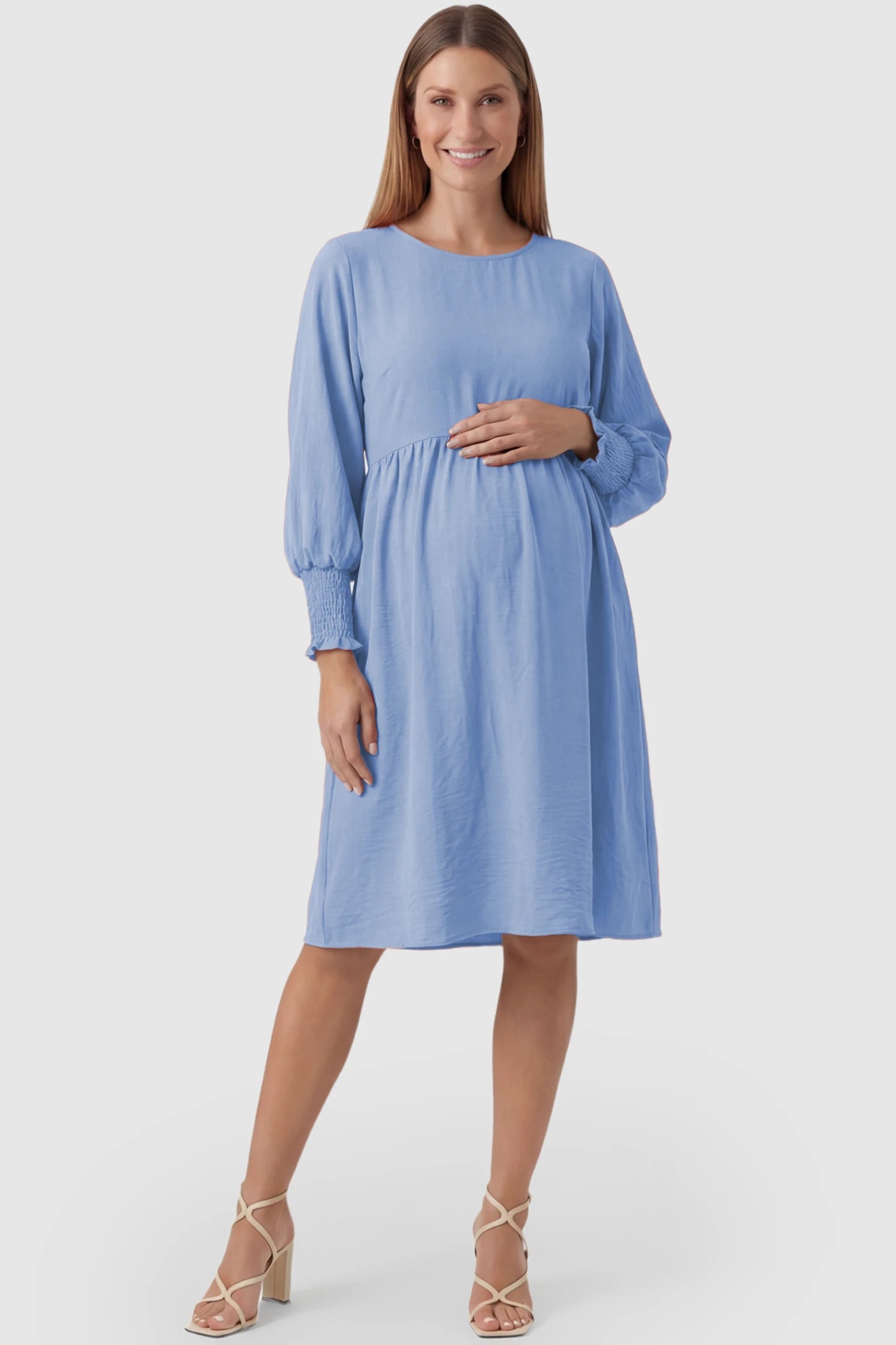 Balloon Sleeve Empire Waist Maternity Midi Dress Balloon Sleeve Empire Waist Maternity Midi Dress in light blue featuring smocked elastic cuff sleeves and soft drape on a pregnant model, front view.