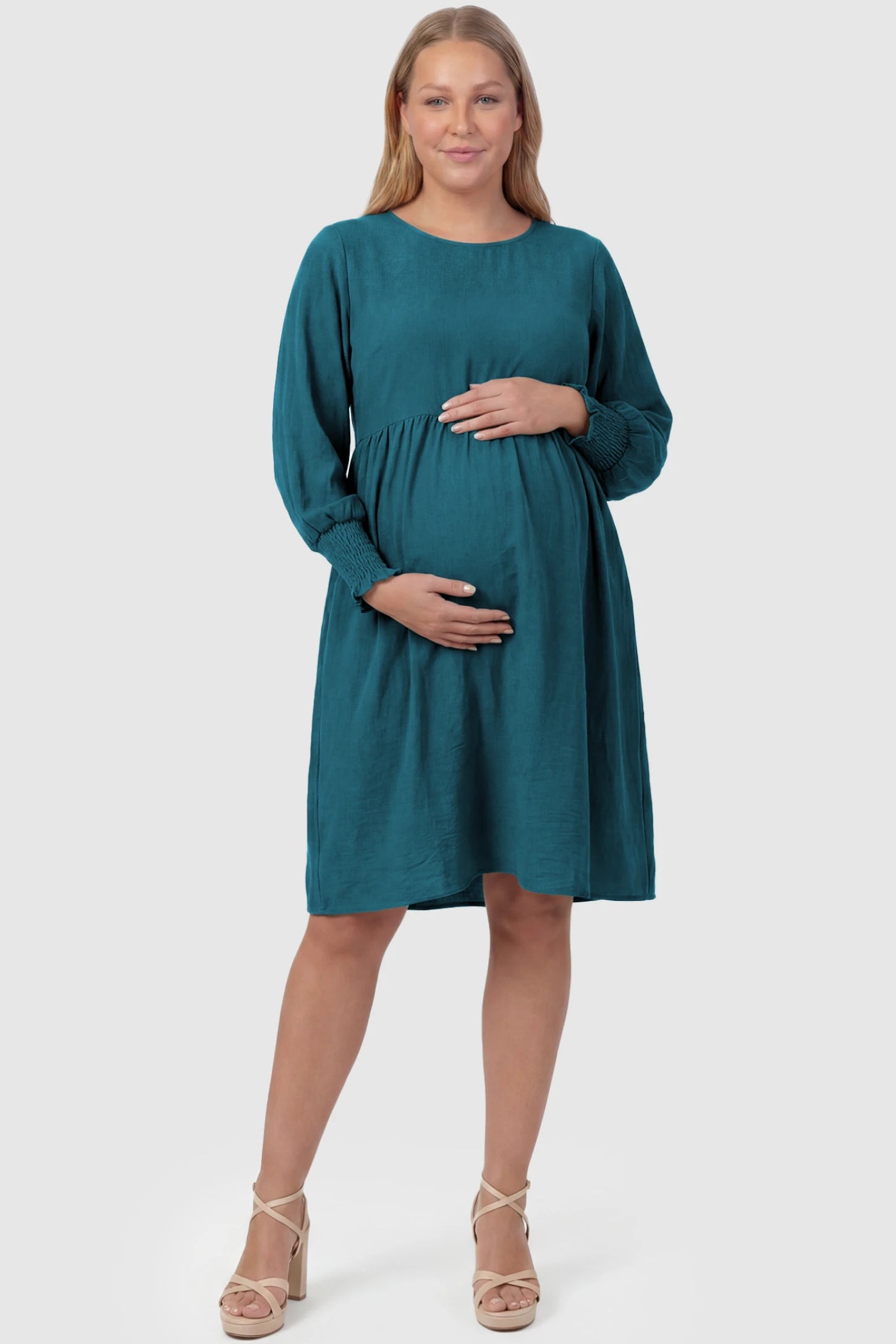 Balloon Sleeve Empire Waist Maternity Midi Dress Balloon Sleeve Empire Waist Maternity Midi Dress in peacock blue featuring smocked elastic cuff sleeves and soft drape on a plus size pregnant model, front view.
