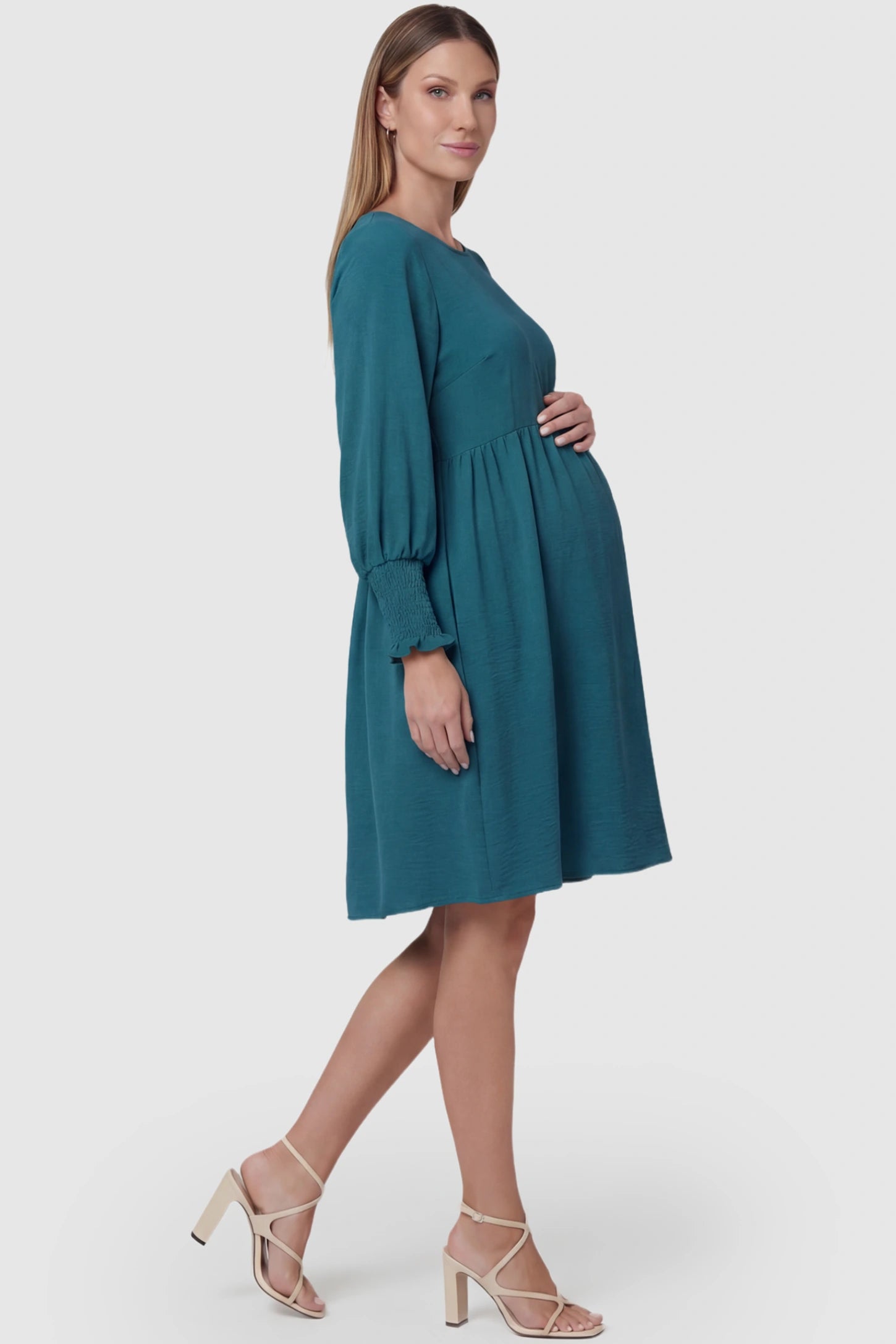 Balloon Sleeve Empire Waist Maternity Midi Dress Balloon Sleeve Empire Waist Maternity Midi Dress in peacock blue featuring smocked elastic cuff sleeves and soft drape on a pregnant model, side view.