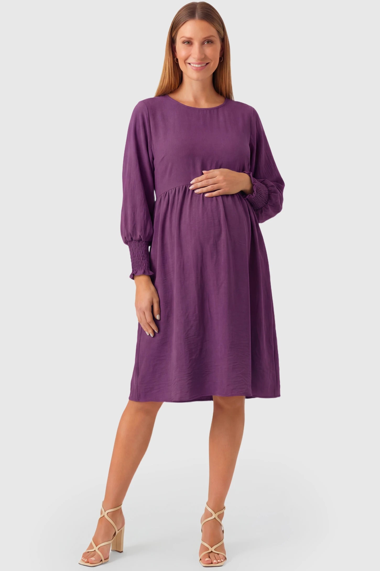 Balloon Sleeve Empire Waist Maternity Midi Dress Balloon Sleeve Empire Waist Maternity Midi Dress in purple featuring smocked elastic cuff sleeves and soft drape on a pregnant model.