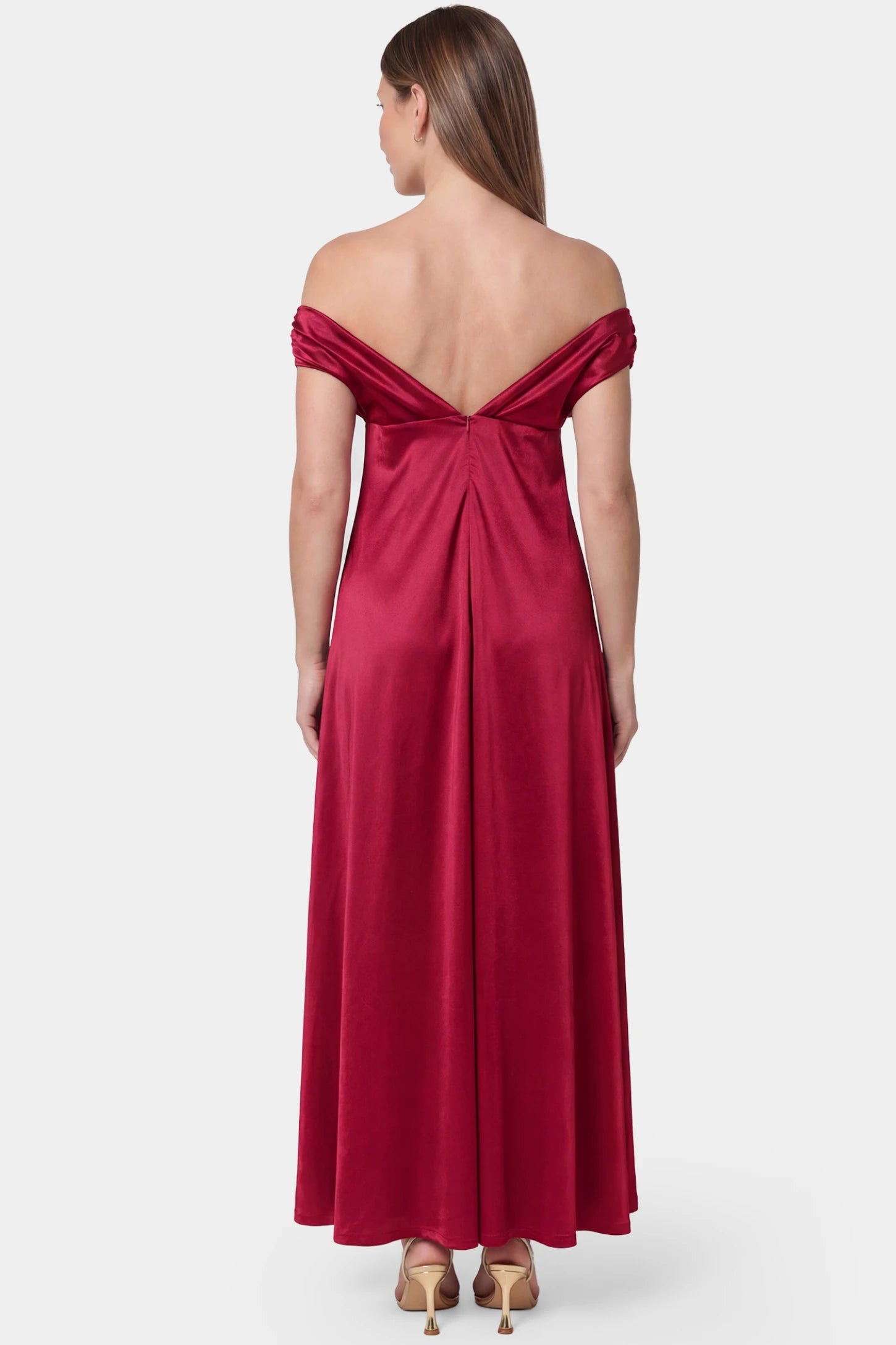 Off-Shoulder Fitted Waist Flowing Maxi Maternity Dress Off-shoulder fitted waist flowing maxi maternity dress in red featuring off-the-shoulder V-back design in back view on a pregnant model
