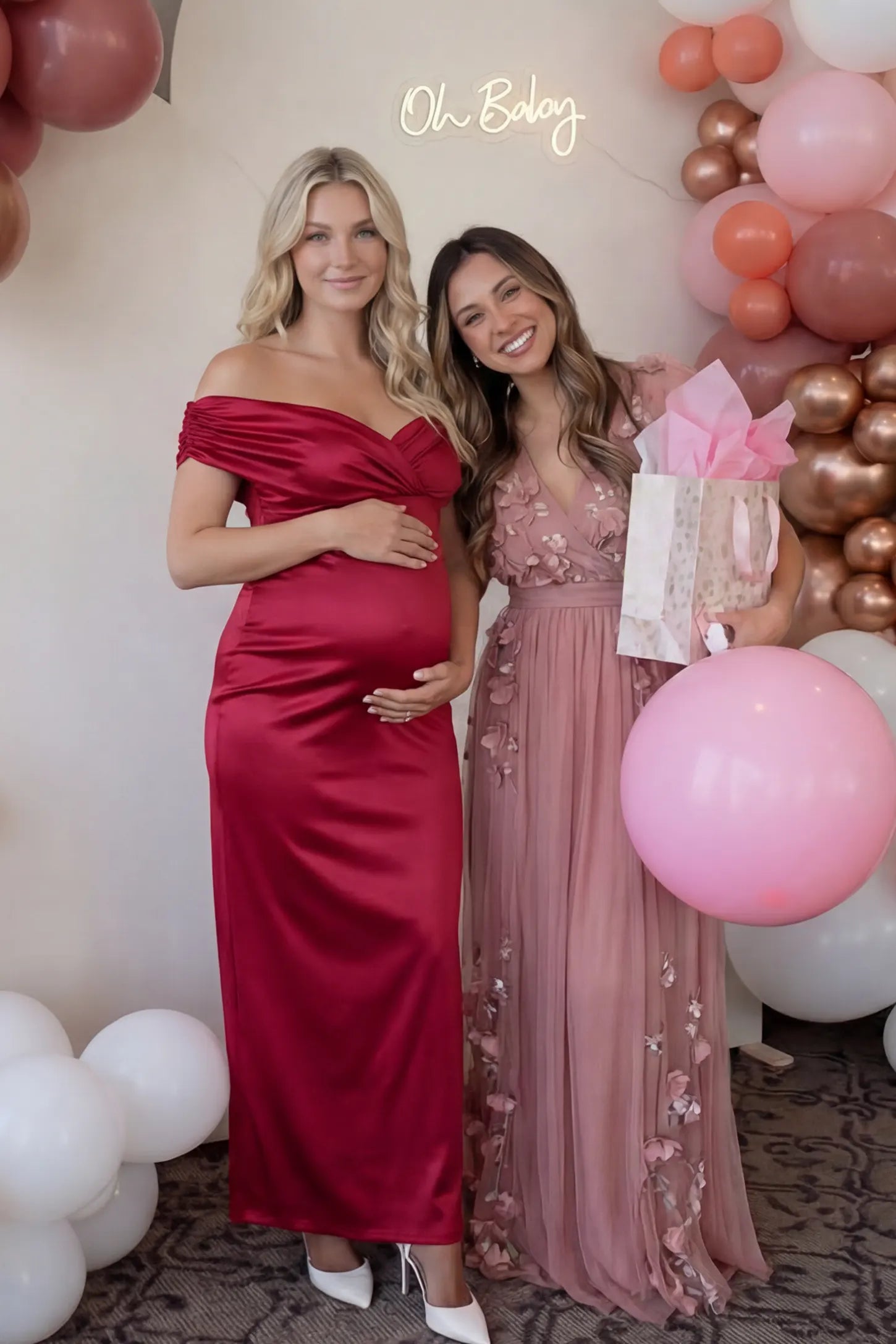 Off-Shoulder Fitted Waist Flowing Maxi Maternity Dress Off-shoulder fitted waist flowing maxi maternity dress in red featuring off-shoulder neckline in front view on a pregnant model