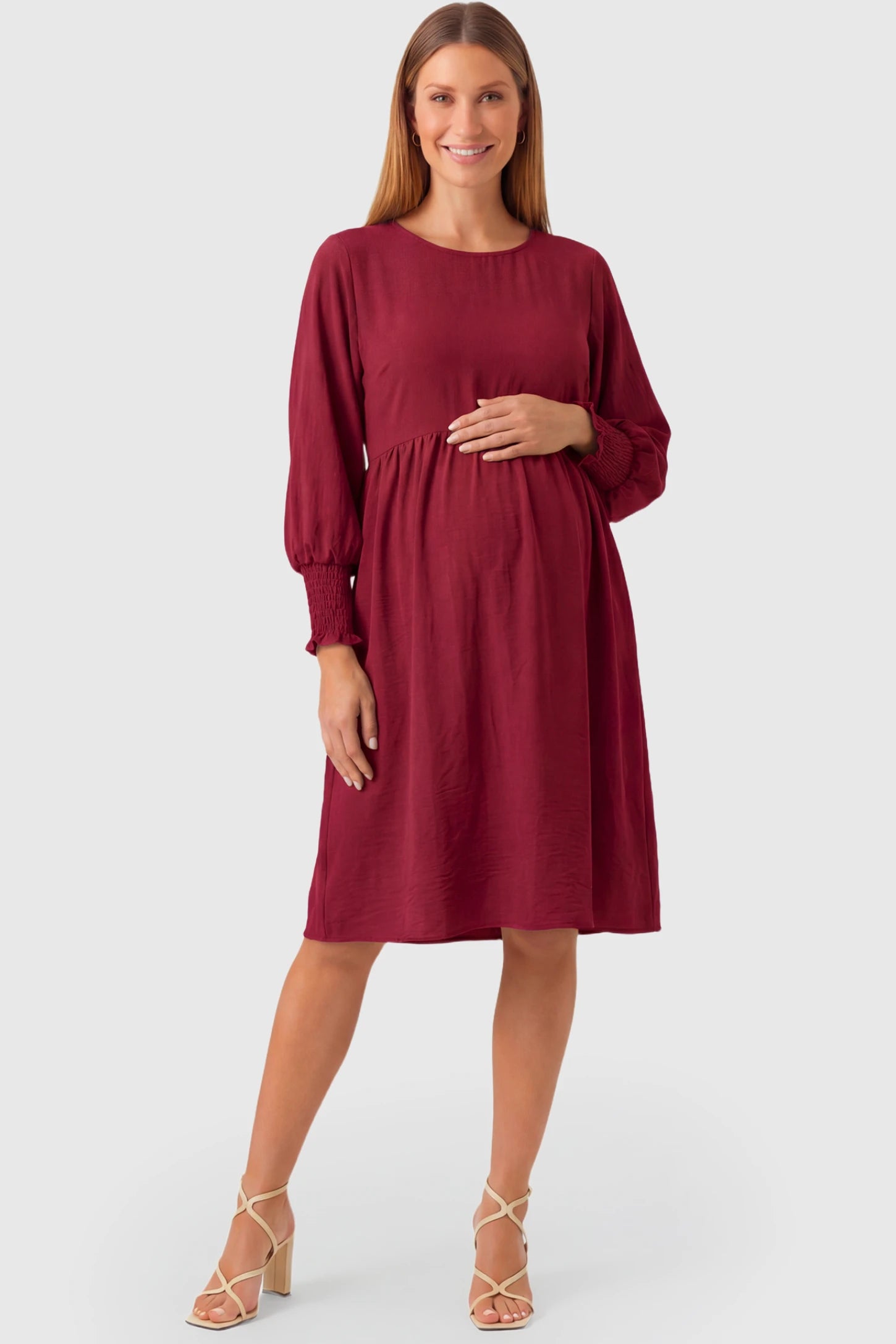 Balloon Sleeve Empire Waist Maternity Midi Dress Balloon Sleeve Empire Waist Maternity Midi Dress in red featuring smocked elastic cuff sleeves and soft drape on a pregnant model.