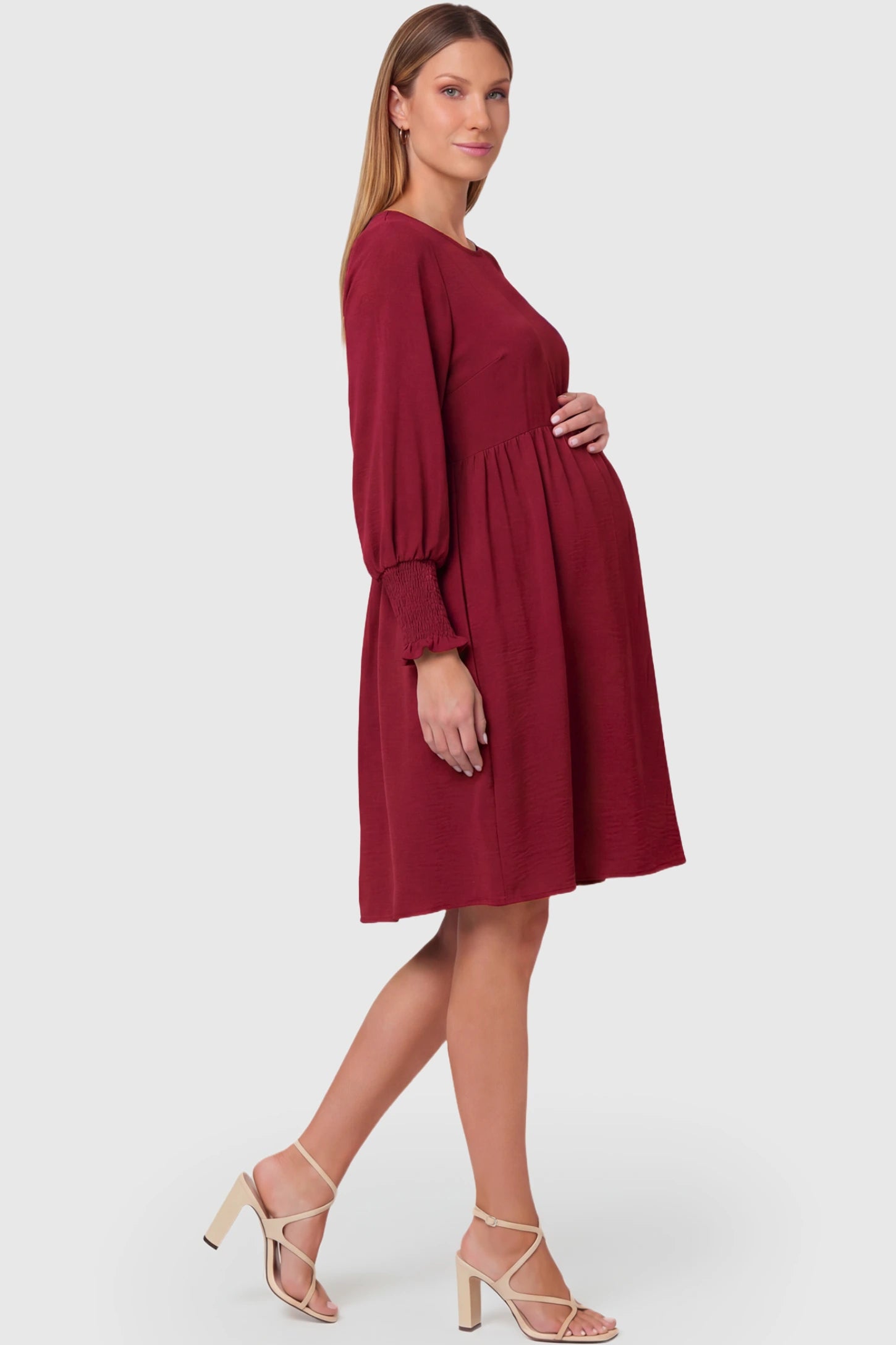 Balloon Sleeve Empire Waist Maternity Midi Dress Balloon Sleeve Empire Waist Maternity Midi Dress in red featuring smocked elastic cuff sleeves and soft drape on a pregnant model.