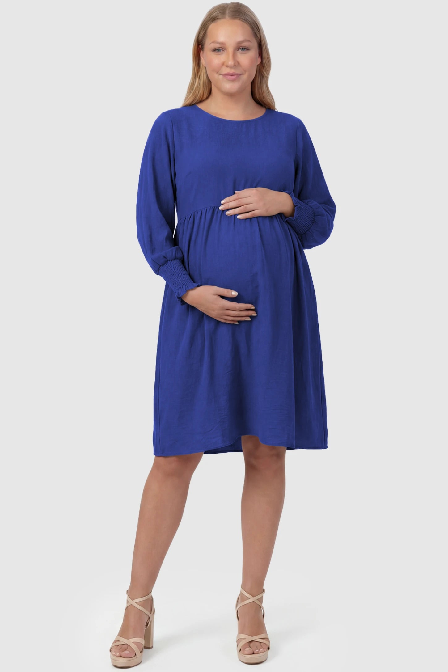 Balloon Sleeve Empire Waist Maternity Midi Dress Balloon Sleeve Empire Waist Maternity Midi Dress in blue featuring smocked elastic cuff sleeves and soft drape on a plus size pregnant model, front view.