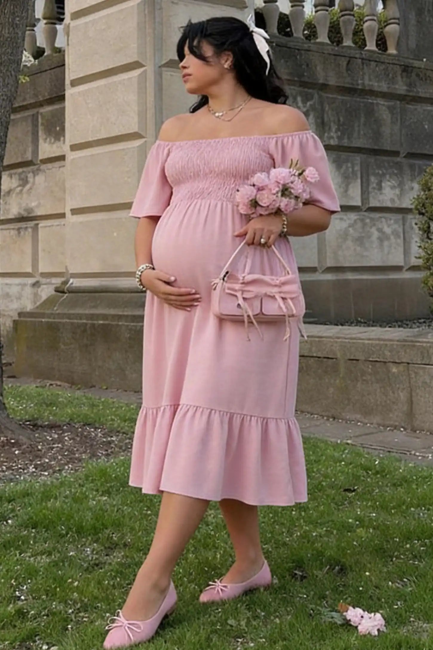 Flutter-Sleeve Smocked Maternity Midi Dress Flutter Sleeve Smocked Maternity Midi Dress in light pink color featuring a flowy silhouette and smocked bodice on a pregnant model.