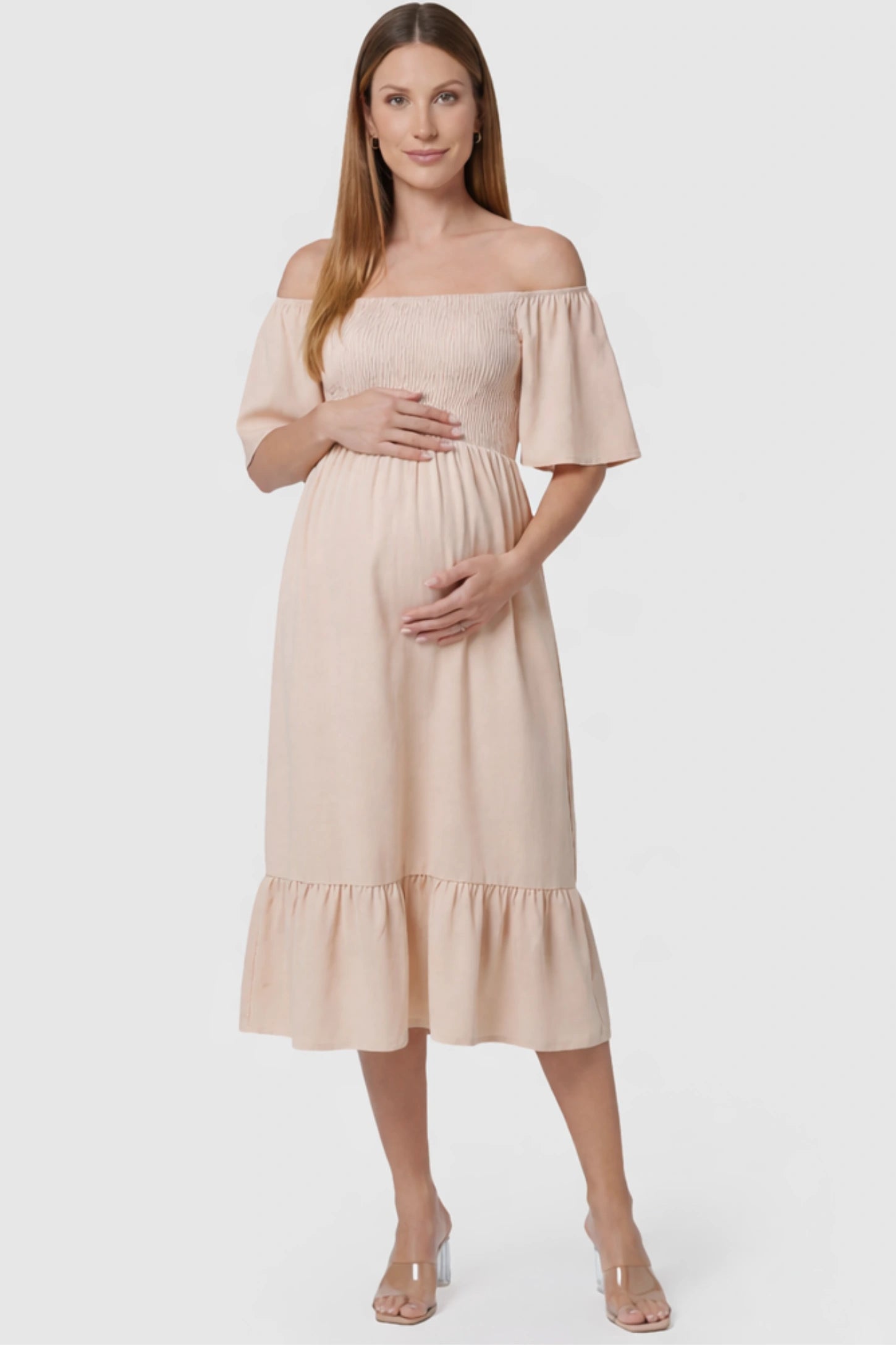 Flutter Sleeve Smocked Maternity Midi Dress in skin color featuring a flowy silhouette and smocked bodice on a pregnant model.