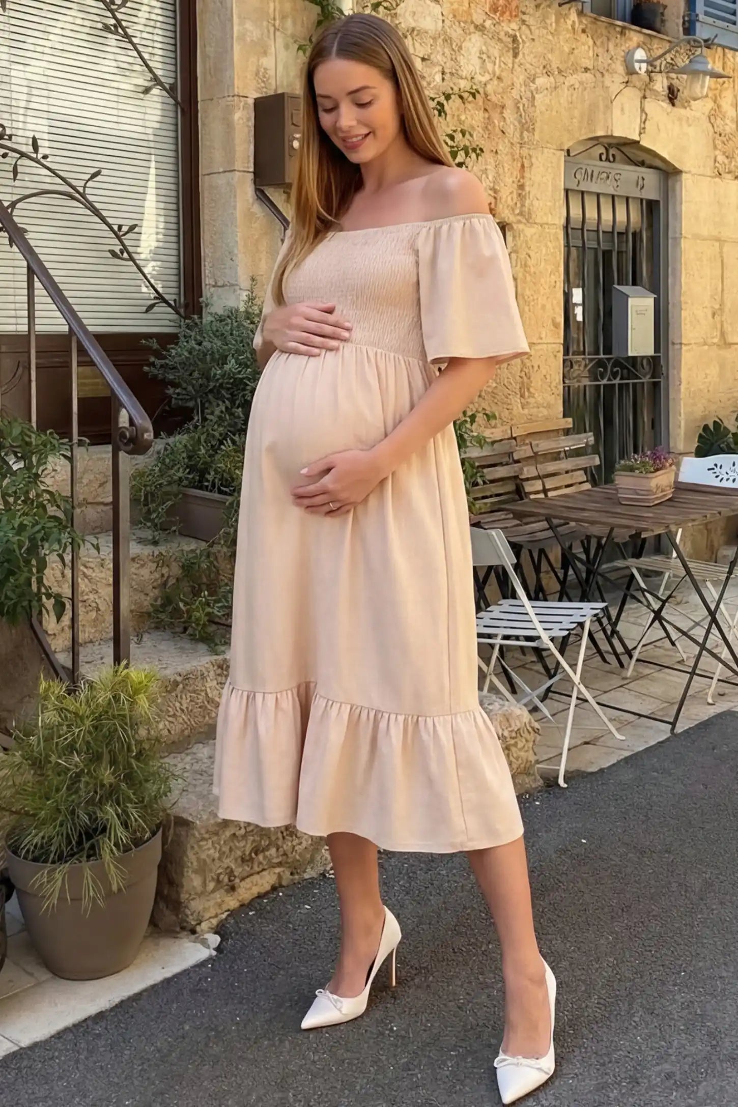 Flutter Sleeve Smocked Maternity Midi Dress in skin color featuring a flowy silhouette and smocked bodice on a pregnant model.