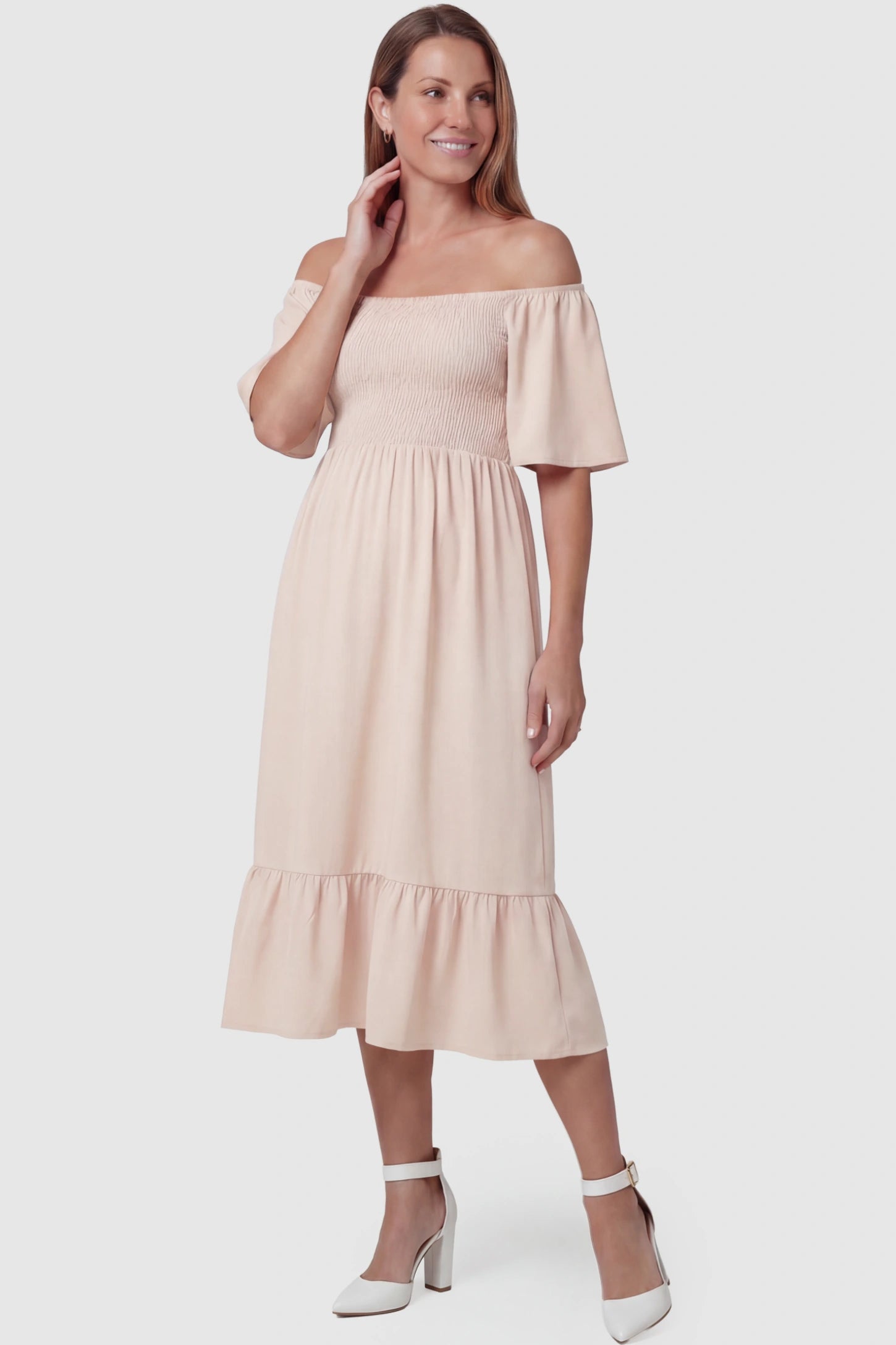 Flutter-Sleeve Smocked Maternity Midi Dress Flutter Sleeve Smocked Maternity Midi Dress in skin color featuring a flowy silhouette and smocked bodice on a non pregnant model.