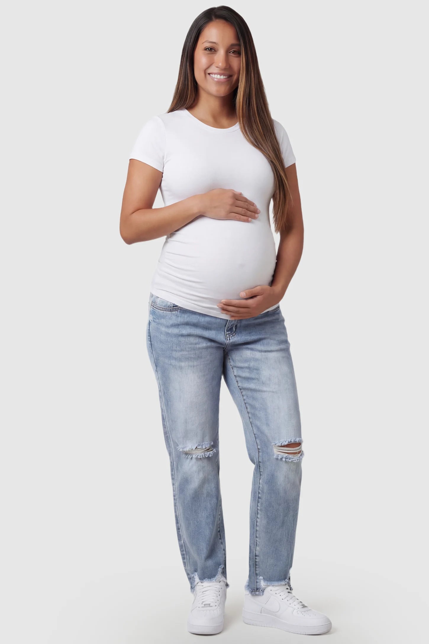 Distressed Straight-Leg Maternity Jeans in light blue featuring knee-ripped detailing and frayed hem on pregnant model.