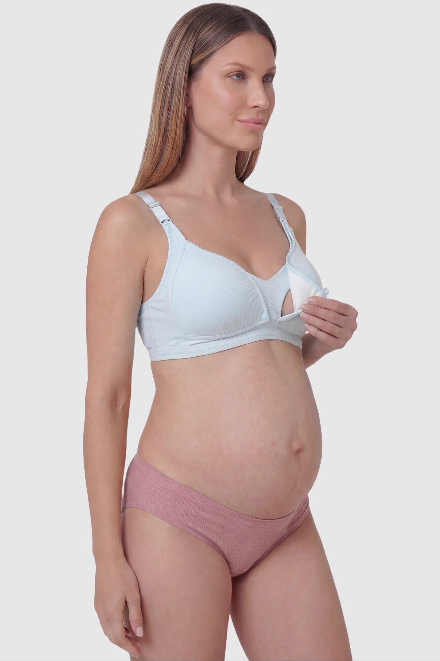 Front-Open Snap Wire-Free Maternity Nursing Bra Front-Open Buckle Wire-Free Maternity Nursing Bra in Blue featuring breathable cotton fabric on a side view of a pregnant model.