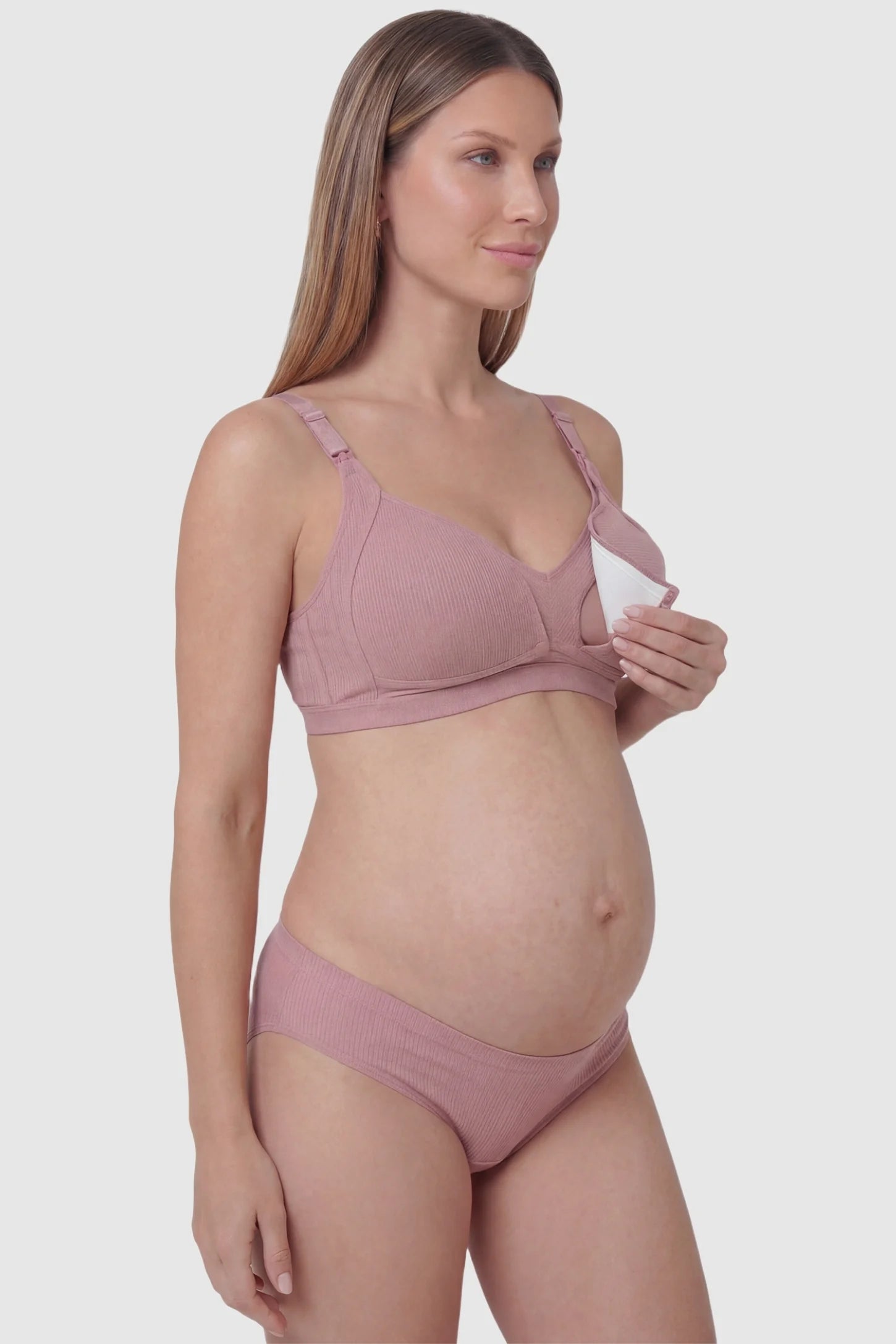 Front-Open Snap Wire-Free Maternity Nursing Bra Front-Open Buckle Wire-Free Maternity Nursing Bra in Dusty Rose featuring breathable cotton fabric on a side view of a pregnant model.