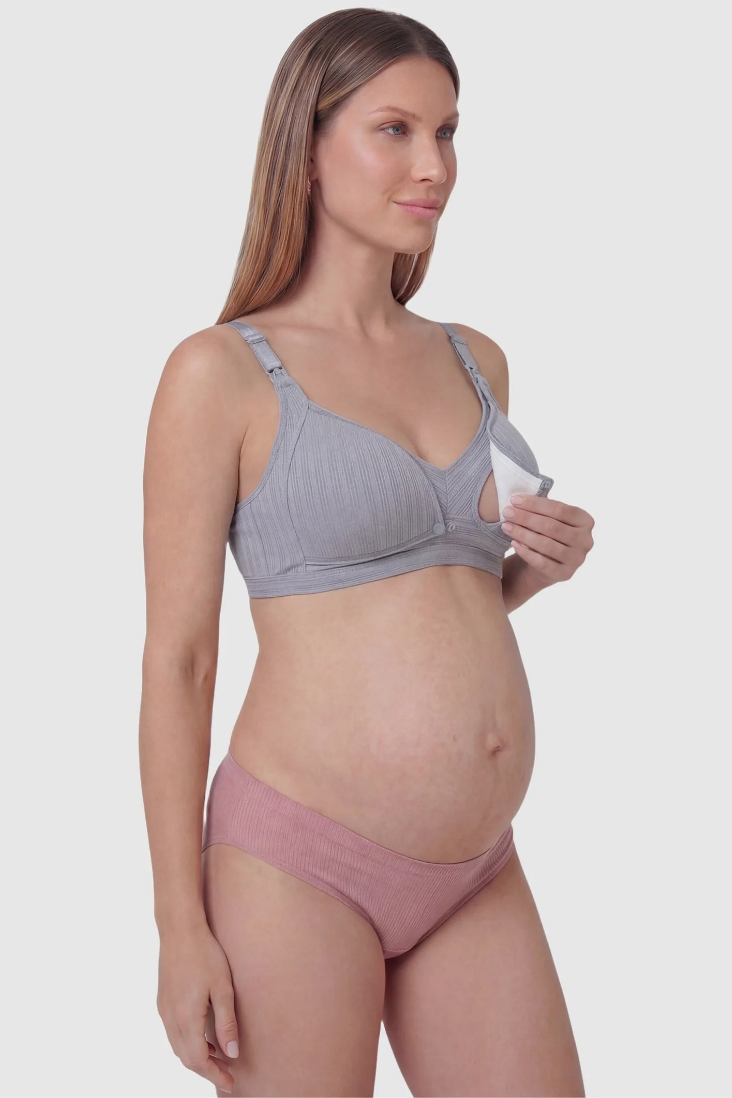 Front-Open Snap Wire-Free Maternity Nursing Bra Front-Open Buckle Wire-Free Maternity Nursing Bra in Gray featuring breathable cotton fabric on a side view of a pregnant model.