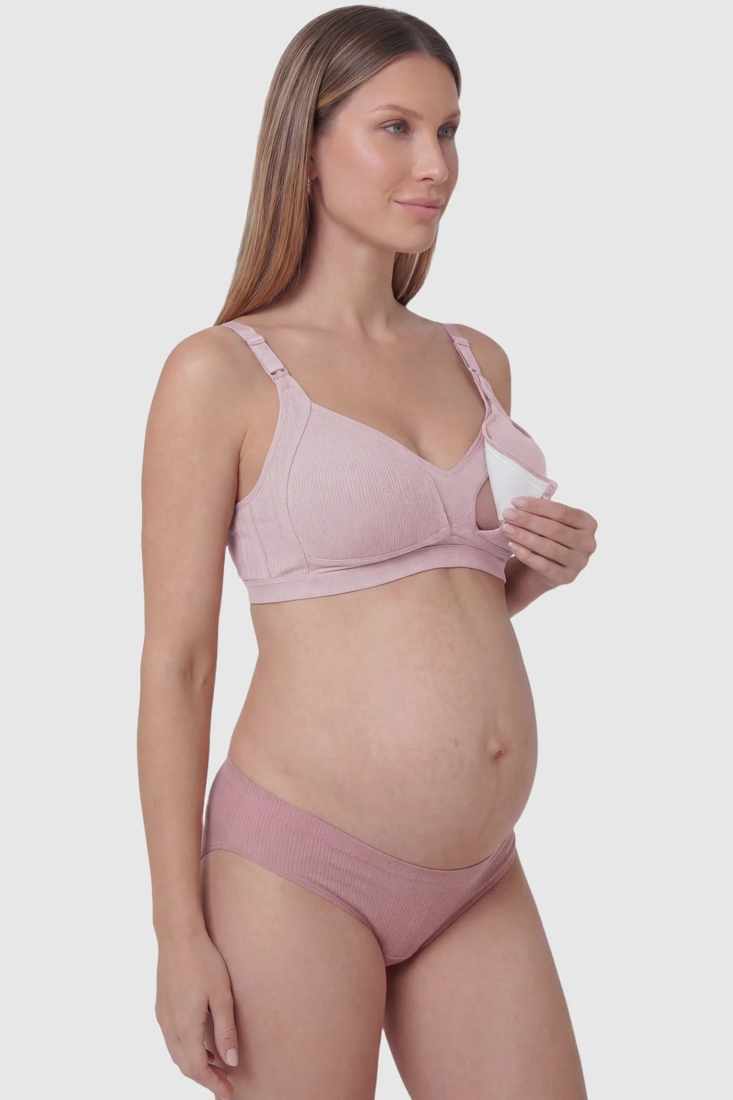 Front-Open Snap Wire-Free Maternity Nursing Bra Front-Open Buckle Wire-Free Maternity Nursing Bra in Pink featuring breathable cotton fabric on a side view of a pregnant model.