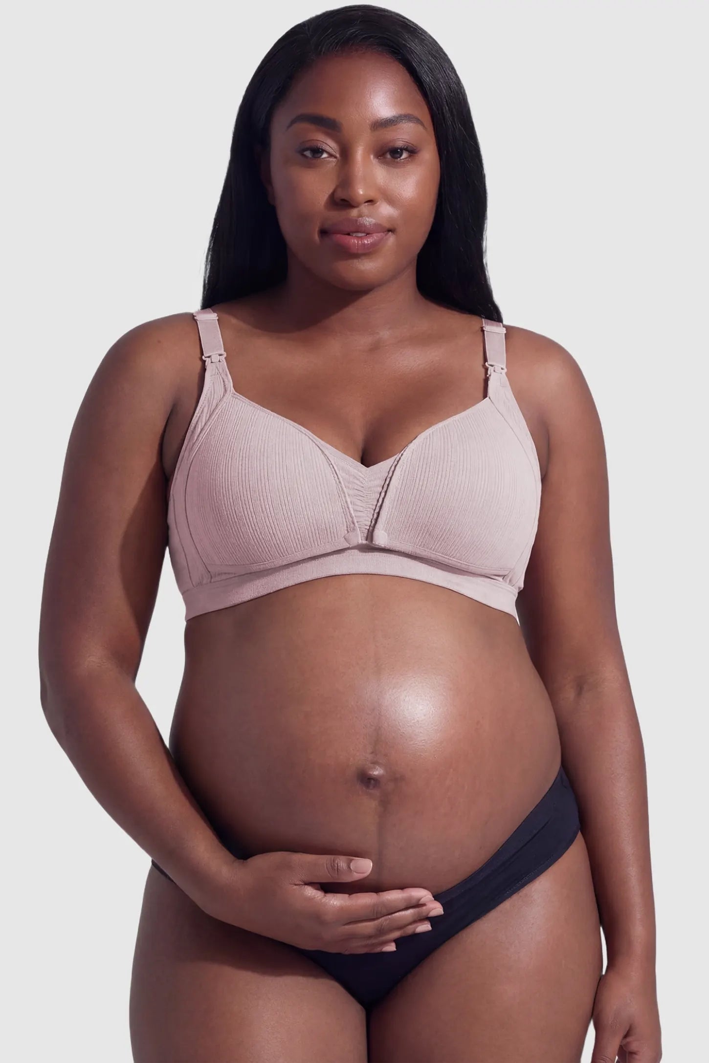 Front-Open Snap Wire-Free Maternity Nursing Bra Front-Open Buckle Wire-Free Maternity Nursing Bra in Pink featuring supportive wire-free cups on a front view of a plus size pregnant model.
