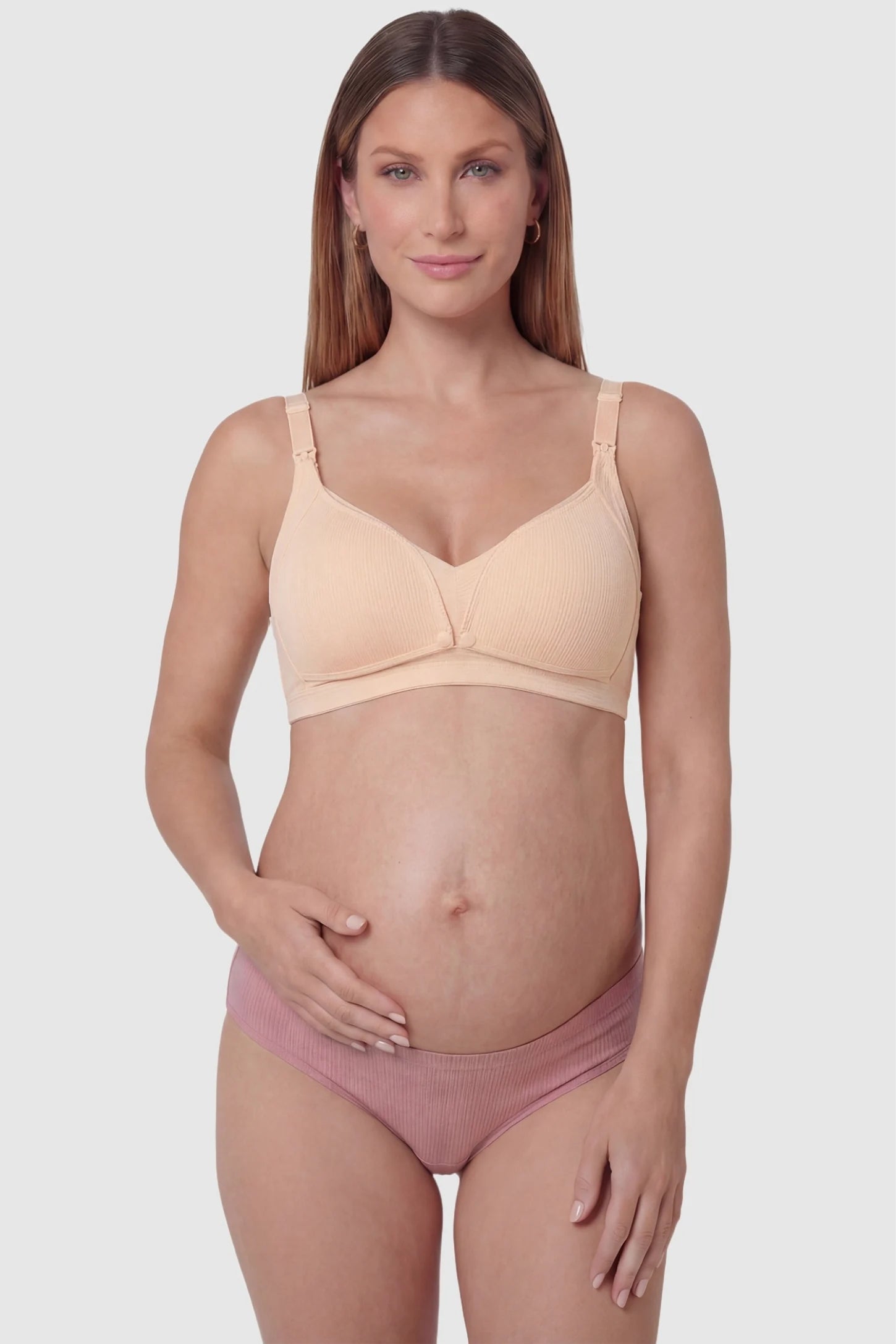 Front-Open Snap Wire-Free Maternity Nursing Bra Front-Open Buckle Wire-Free Maternity Nursing Bra in Skin featuring one-second release snaps on a front view of a pregnant model.