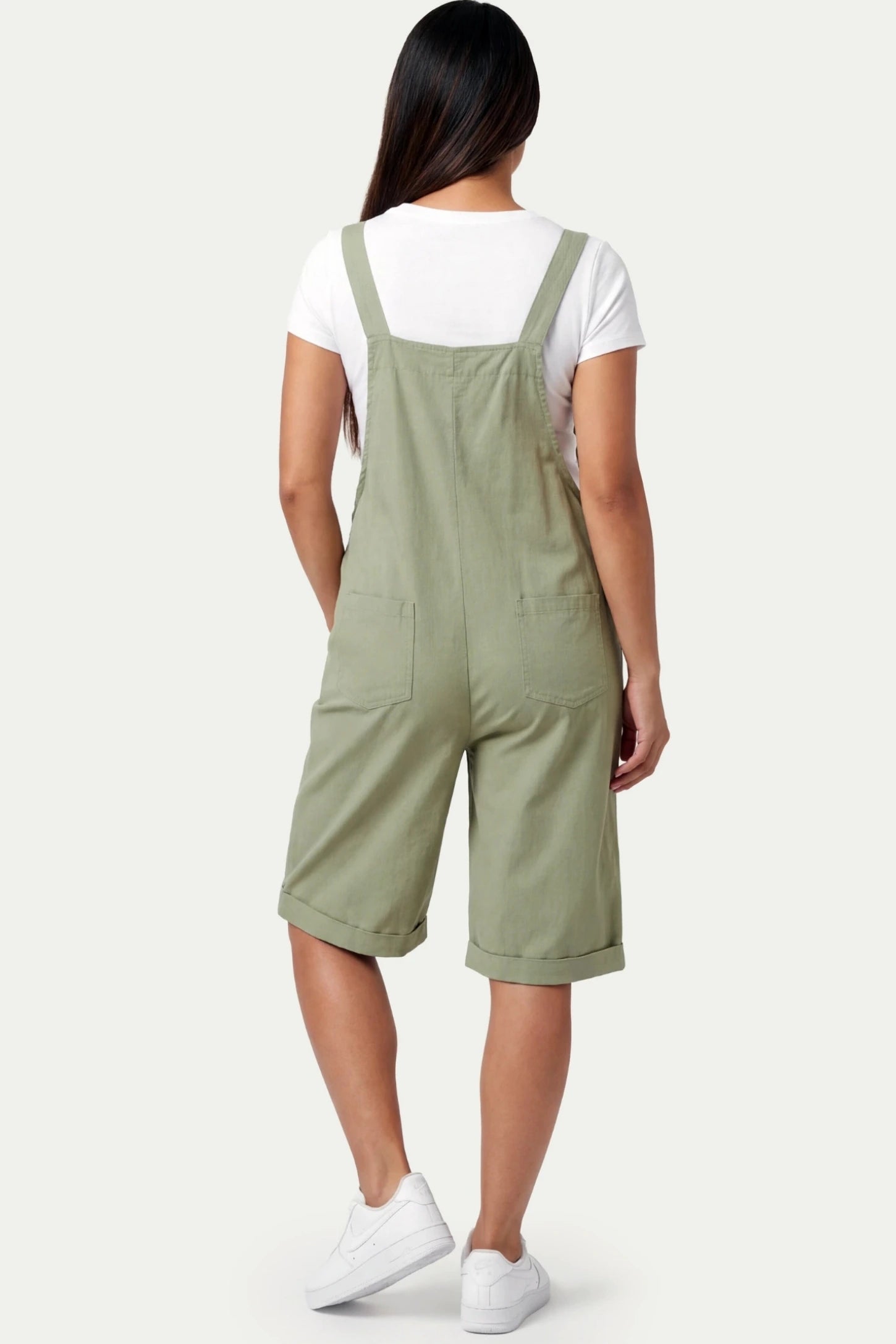 Oversized Front Pocket Maternity Overalls Shorts Oversized Front Pocket Maternity Overalls Shorts in Green featuring a back pocket on a pregnant model.