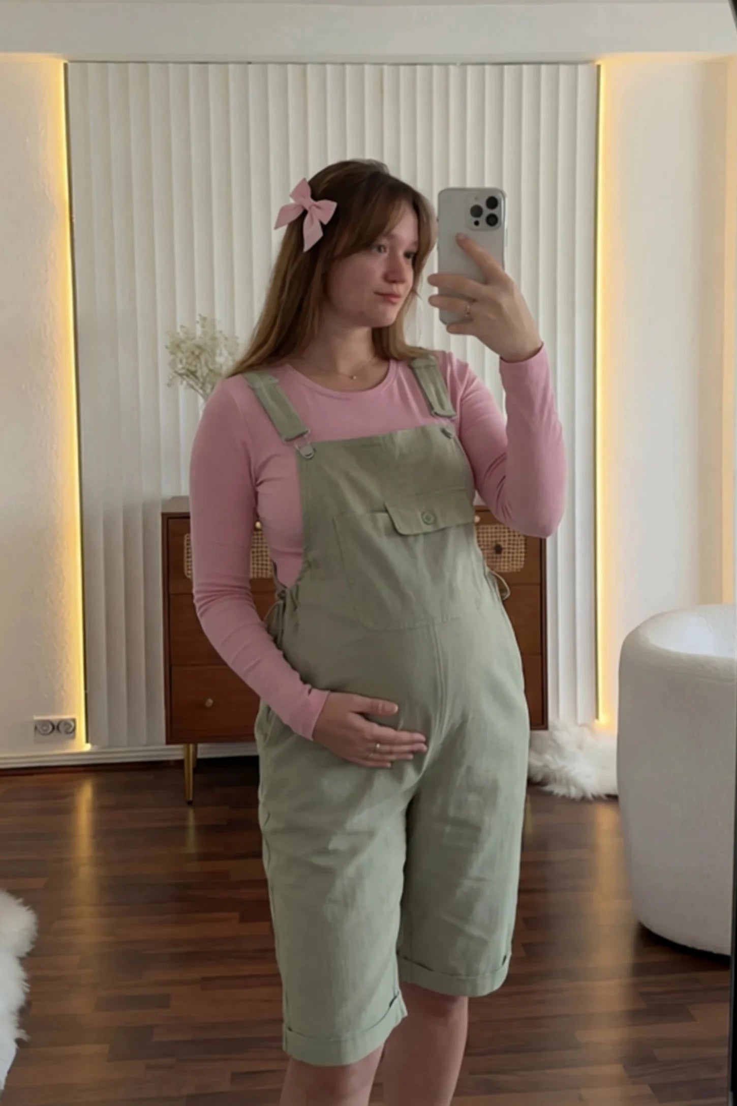 Oversized Front Pocket Maternity Overalls Shorts Oversized Front Pocket Maternity Overalls Shorts in Green featuring a front bib pocket on a pregnant model