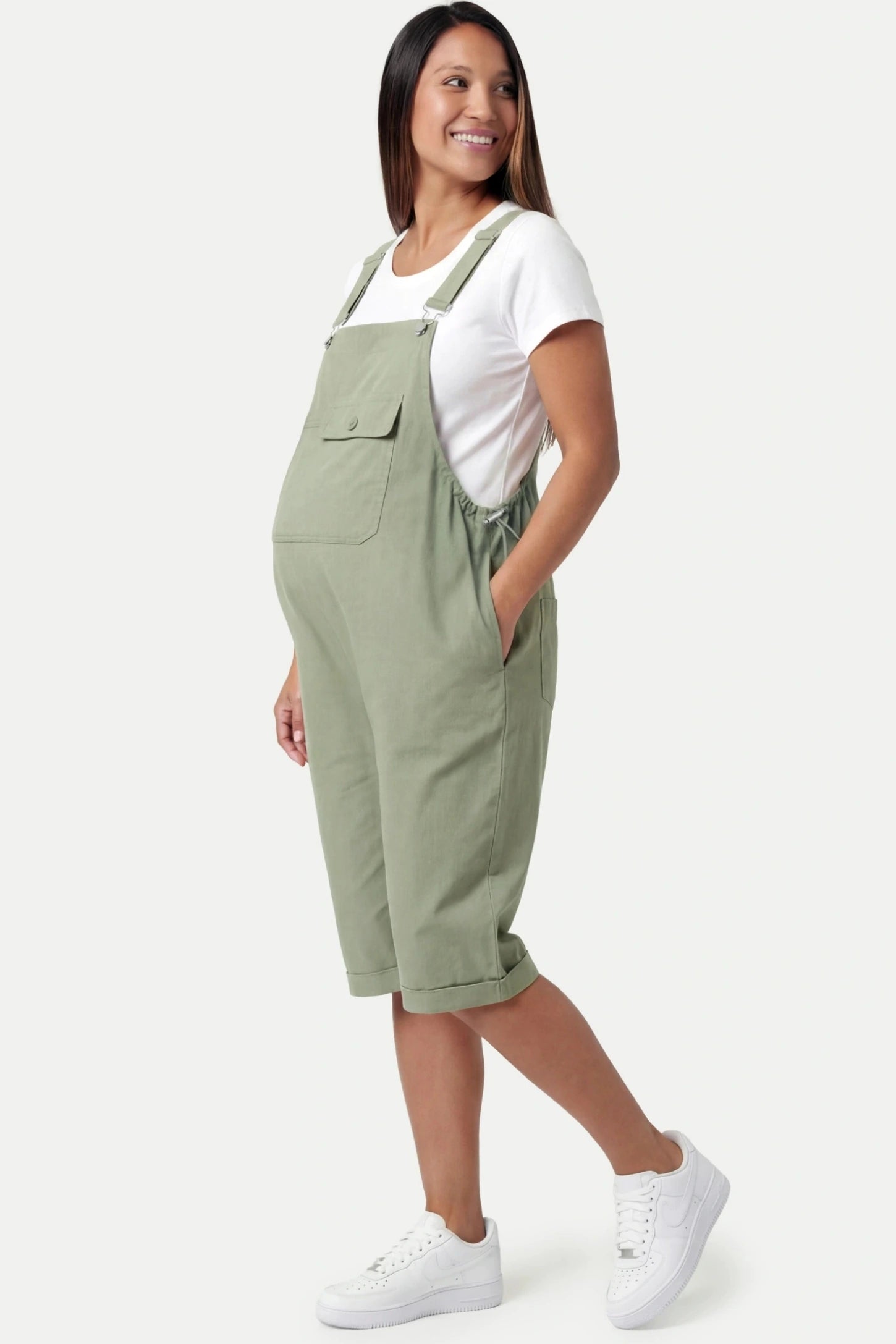 Oversized Front Pocket Maternity Overalls Shorts Oversized Front Pocket Maternity Overalls Shorts in Green featuring a front bib pocket on a pregnant model
