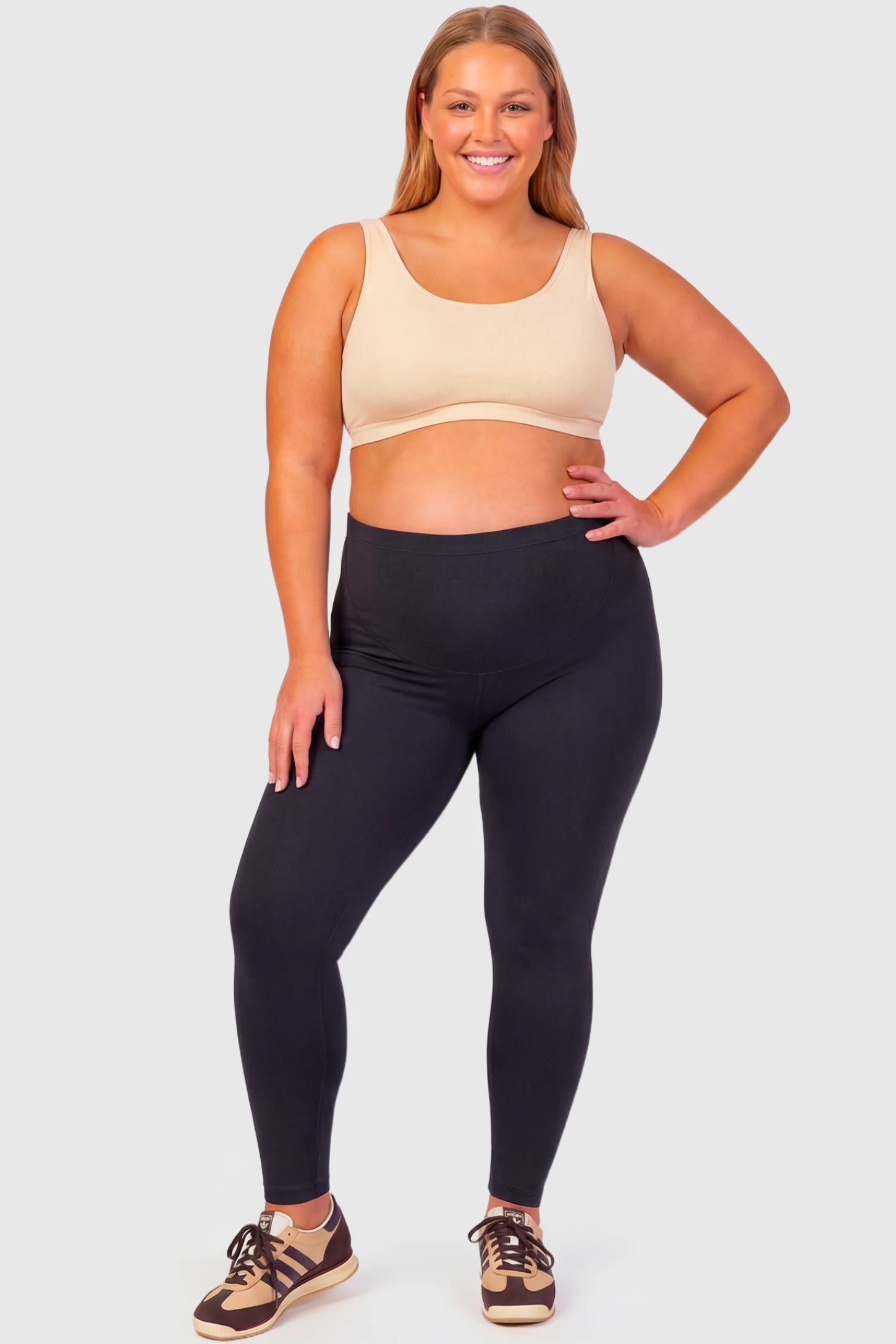 Full-Panel Ankle-Length Maternity Yoga Leggings Full-Panel Ankle-Length Maternity Yoga Leggings in black featuring over-the-belly support and full-length fit on plus size pregnant model.