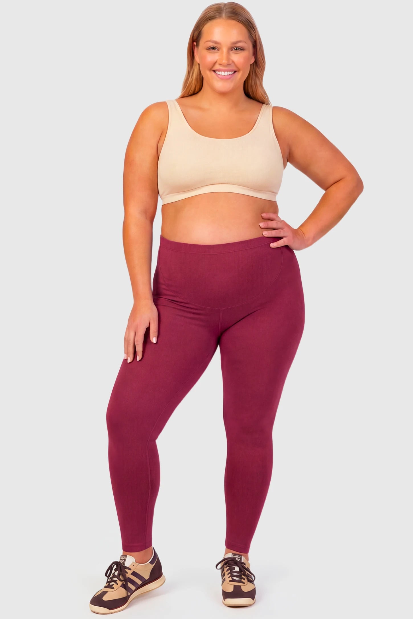 Full-Panel Ankle-Length Maternity Yoga Leggings Full-Panel Ankle-Length Maternity Yoga Leggings in brick red featuring over-the-belly support and full-length fit on plus size pregnant model.