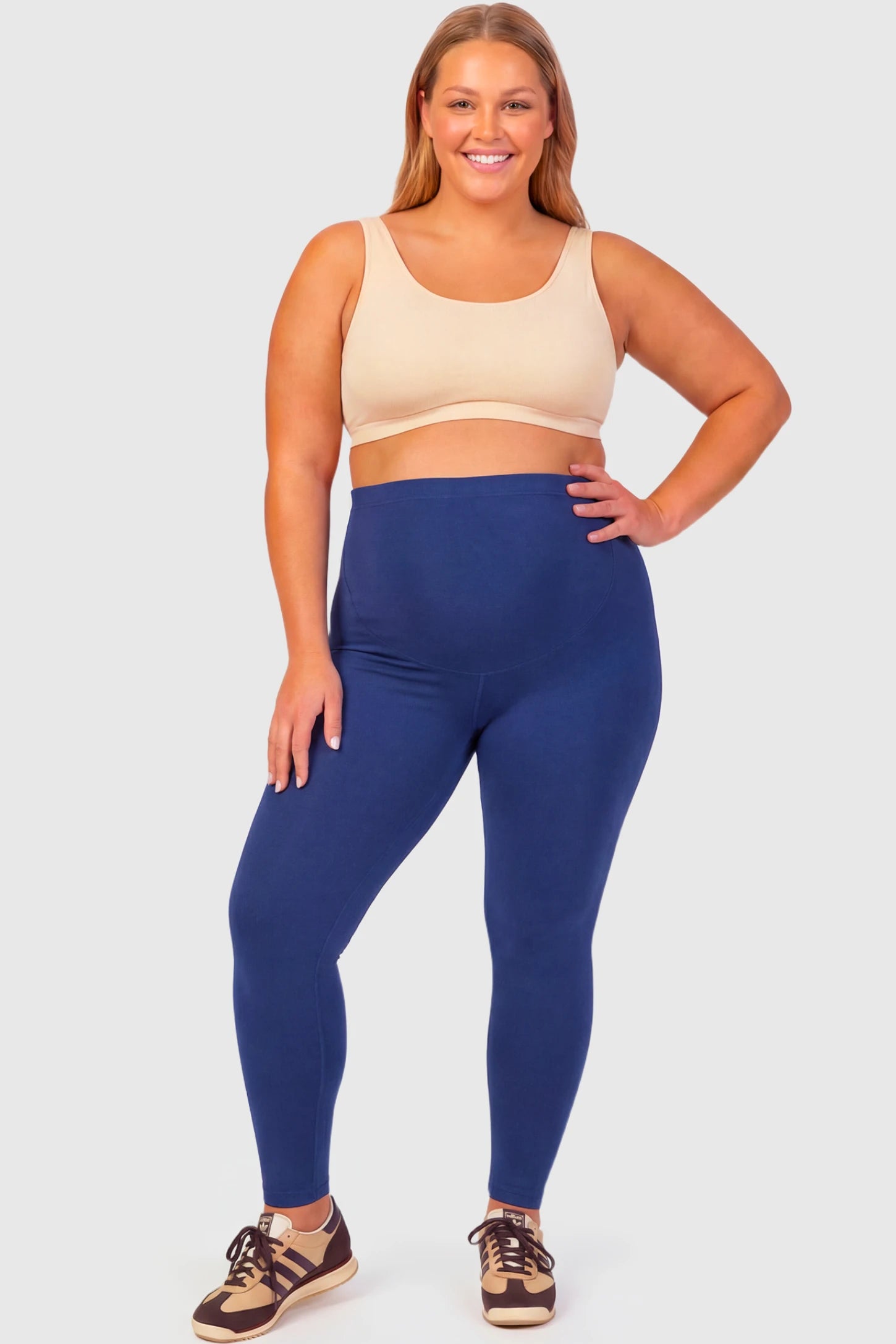 Full-Panel Ankle-Length Maternity Yoga Leggings Full-Panel Ankle-Length Maternity Yoga Leggings in navy blue featuring over-the-belly support and full-length fit on plus size pregnant model.