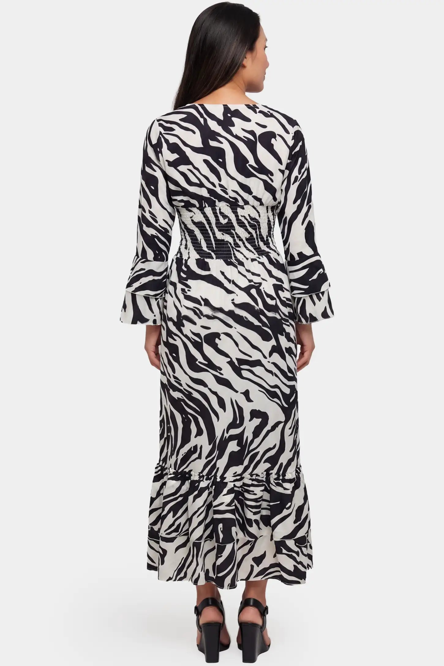 Geometric Stripe Print V-Neck Long Sleeve Tiered Maxi Maternity Dress Geometric stripe print V-neck long sleeve tiered maxi maternity dress in black featuring long sleeves and flowing drape in back view on a pregnant model