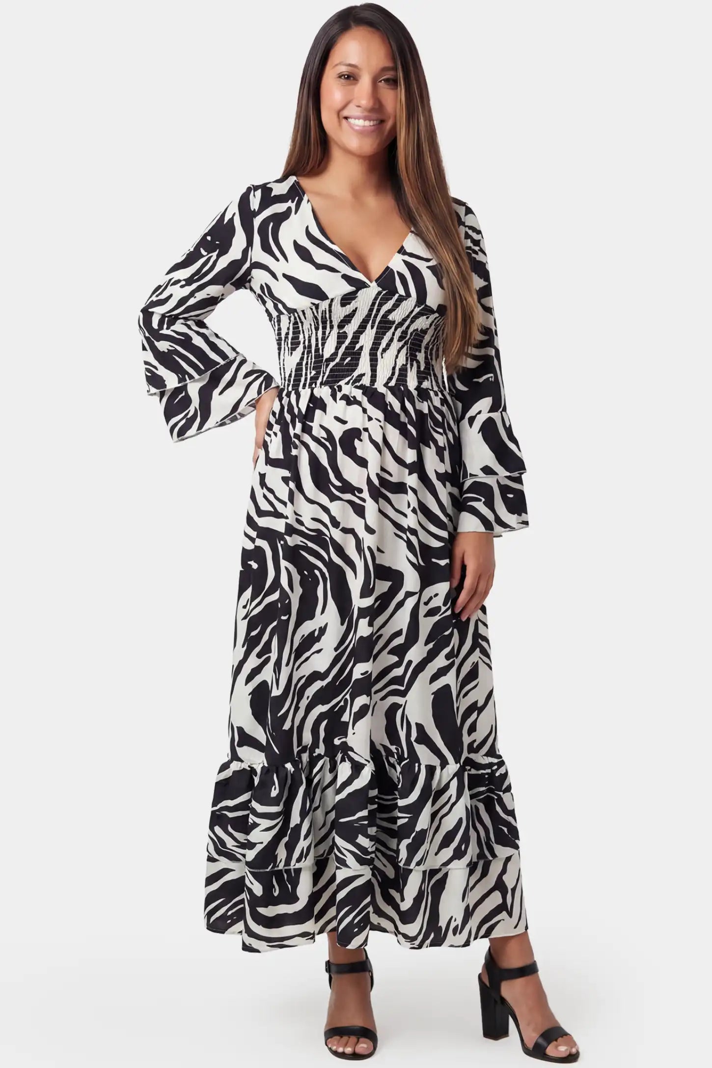 Geometric stripe print V-neck long sleeve tiered maxi maternity dress in black featuring bold stripe pattern in front view on a pregnant model