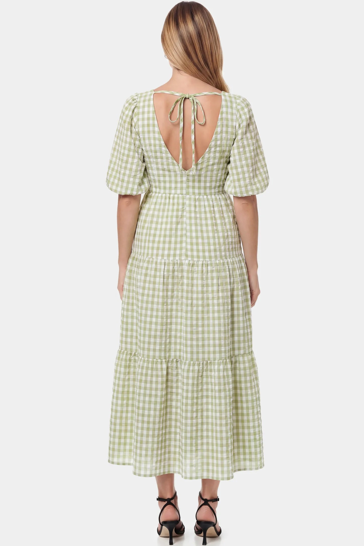 Gingham V-Neck Tiered Maxi Maternity Dress Gingham V-Neck Tiered Maxi Maternity Dress in Green featuring an adjustable tie in back view on a pregnant model