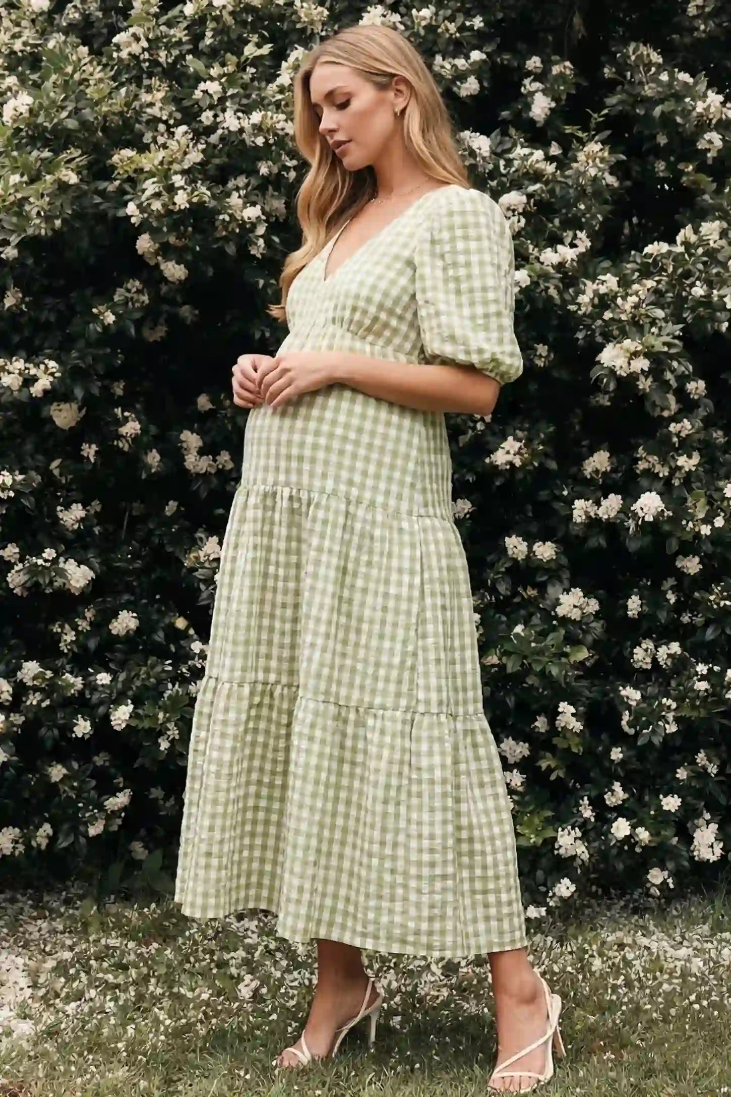 Gingham V-Neck Tiered Maxi Maternity Dress Gingham V-neck tiered maxi maternity dress in green with vintage-inspired gingham pattern, on an editorial lifestyle model