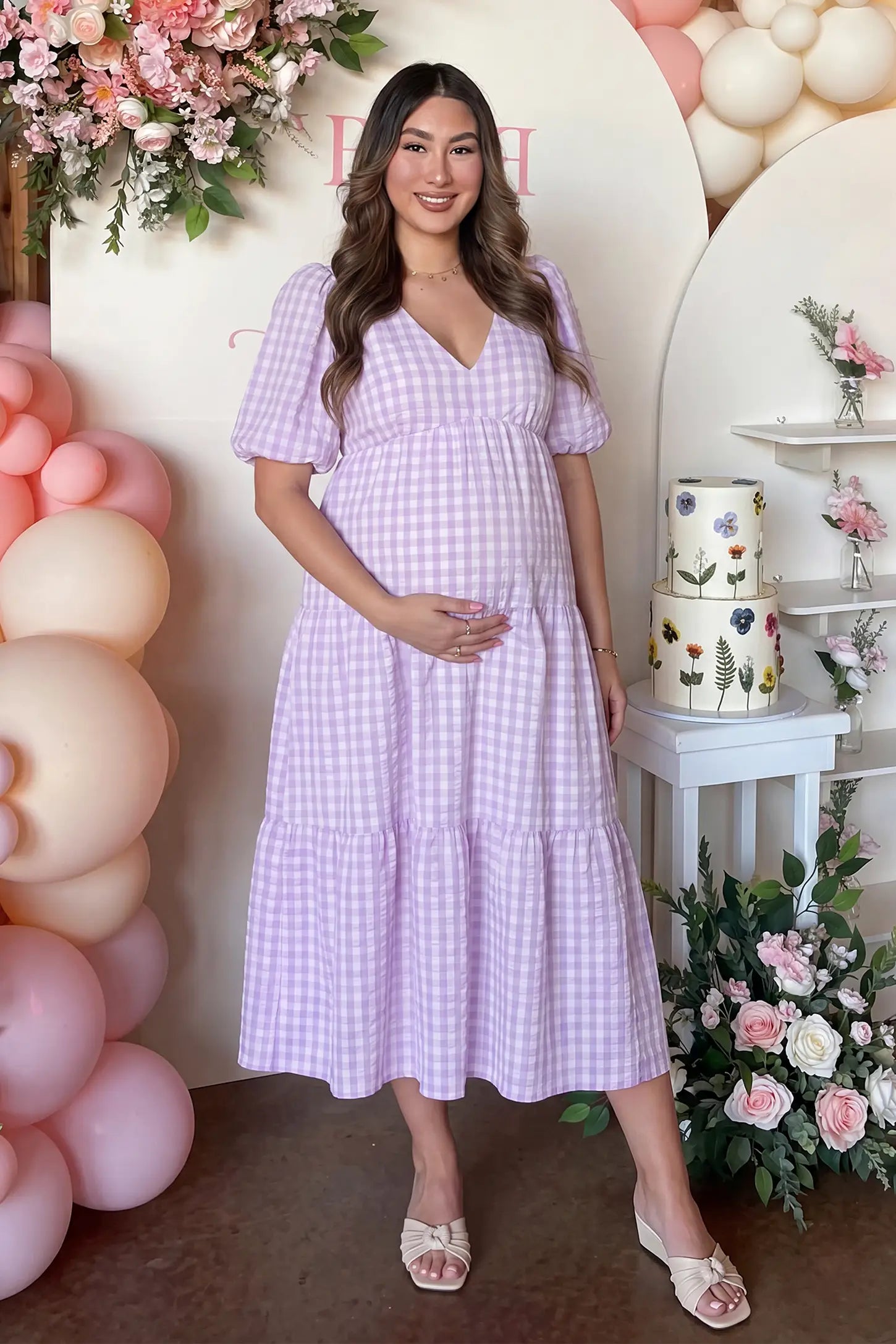 Gingham V-Neck Tiered Midi Maternity Dress Gingham V-neck Tiered Midi Maternity Dress in lavender with vintage-inspired gingham pattern, on an editorial lifestyle model