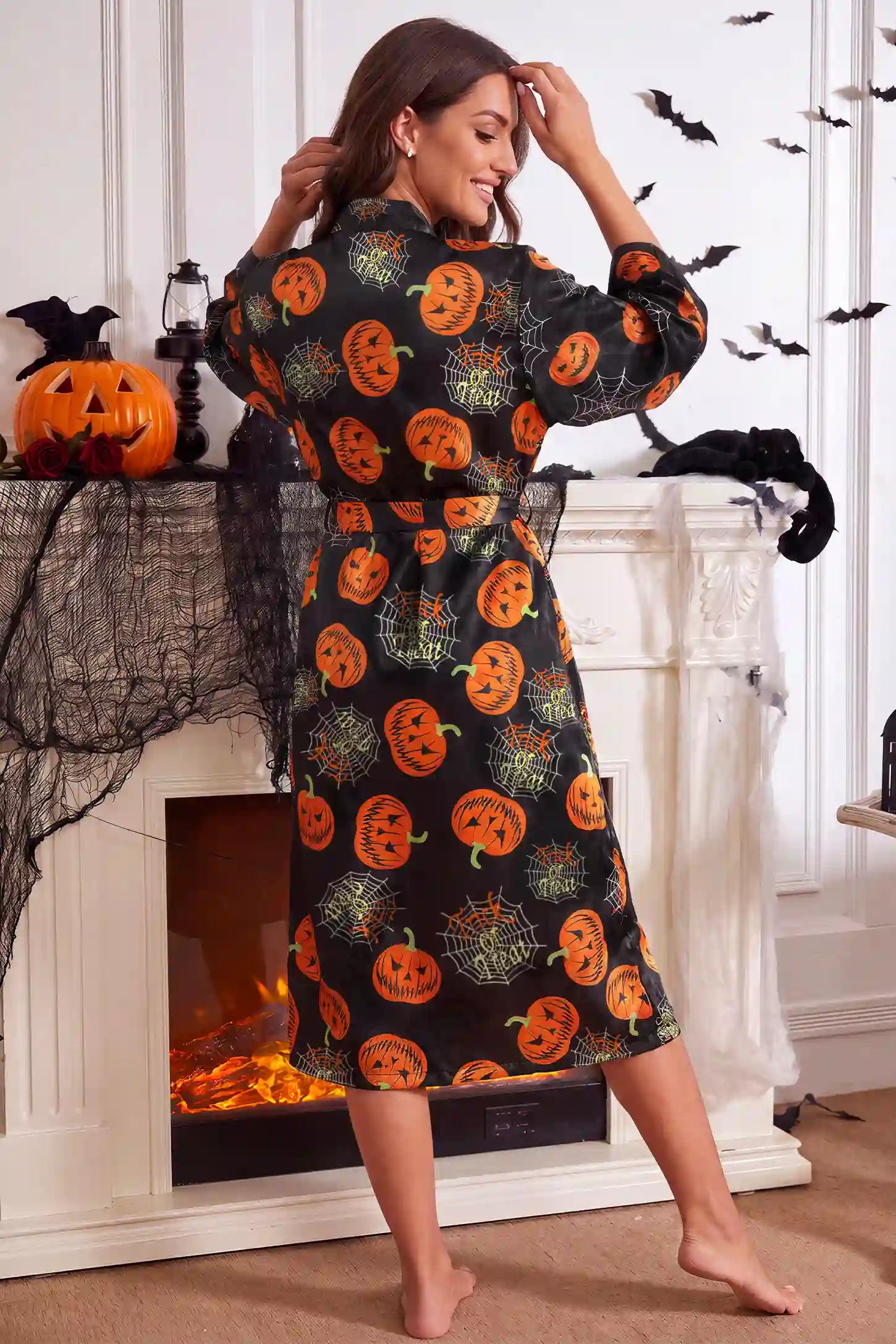 Halloween Pumpkin Print Satin Maternity Lounge Robe Halloween Pumpkin Print Satin Maternity Lounge Robe in Midnight Pumpkin featuring relaxed fit design, smooth satin finish, full back coverage, and easy wrap style on a pregnant model, back view.