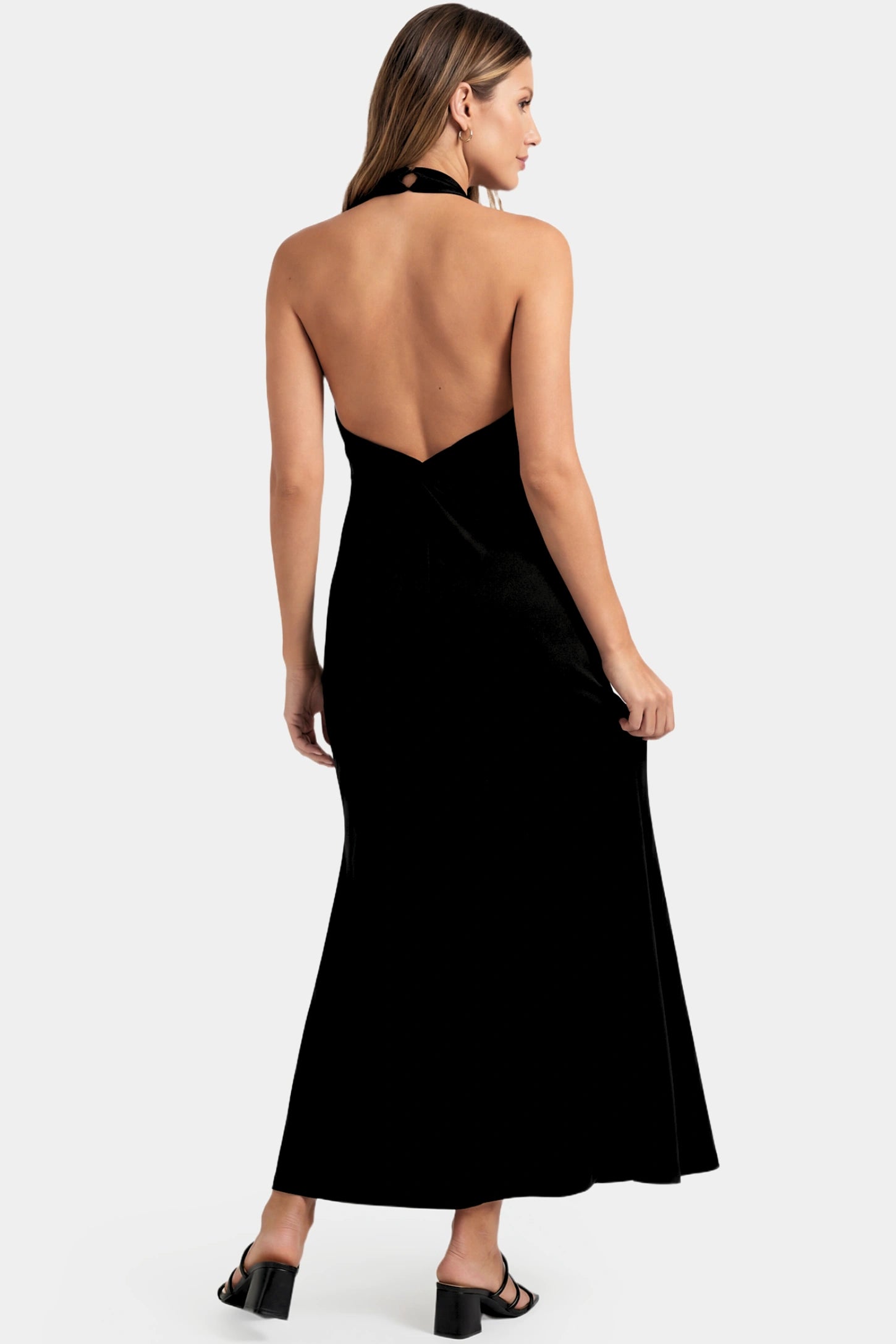 Halter Neck Sleeveless Maternity Maxi Dress Halter Neck Sleeveless Maternity Maxi Dress in black featuring a backless halter neckline and fitted maxi silhouette on a pregnant model.