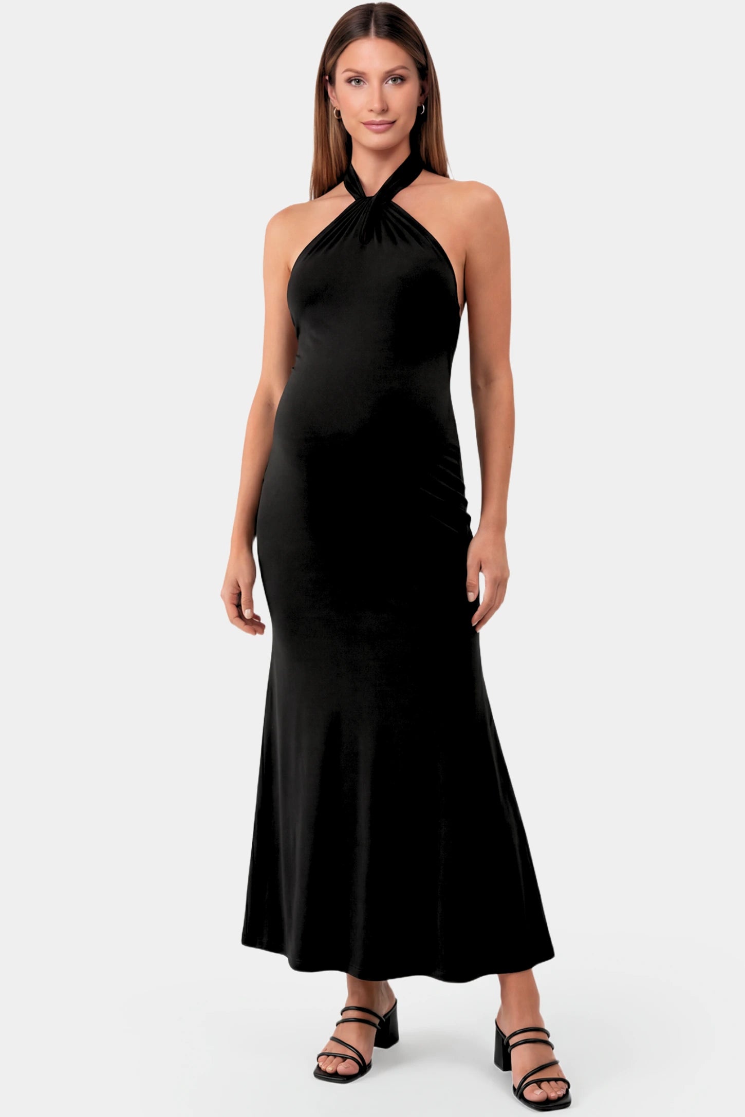 Halter Neck Sleeveless Maternity Maxi Dress in black featuring a backless halter neckline and fitted maxi silhouette on a pregnant model.