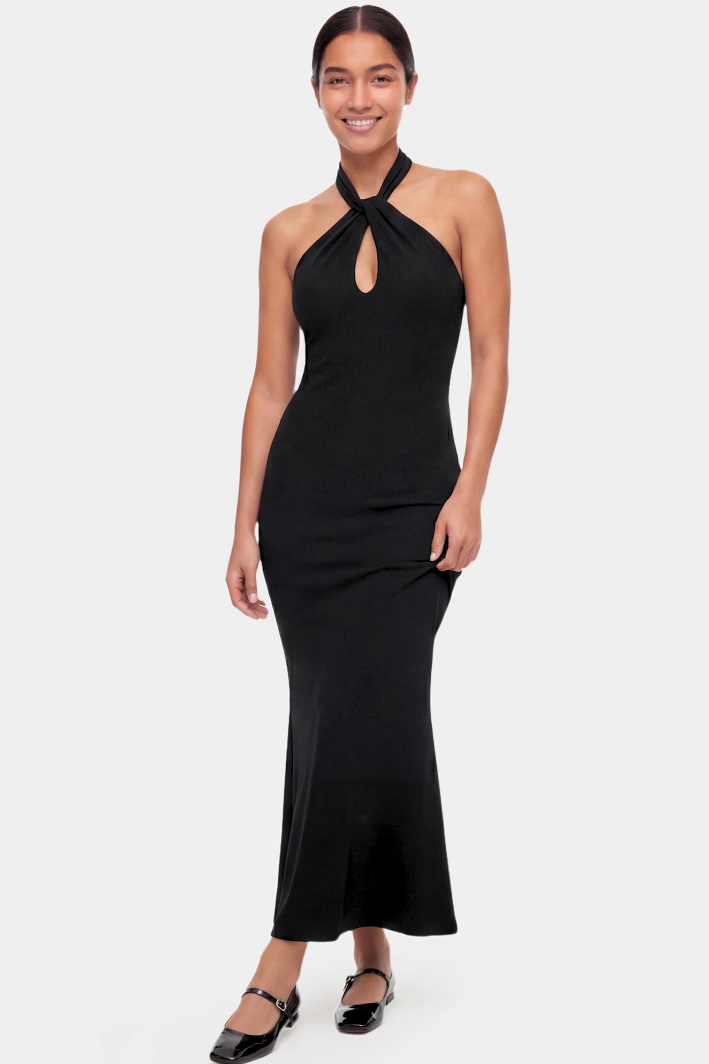 Halter Neck Sleeveless Maternity Maxi Dress Halter Neck Sleeveless Maternity Maxi Dress in black featuring a backless halter neckline and fitted maxi silhouette on a non pregnant model.