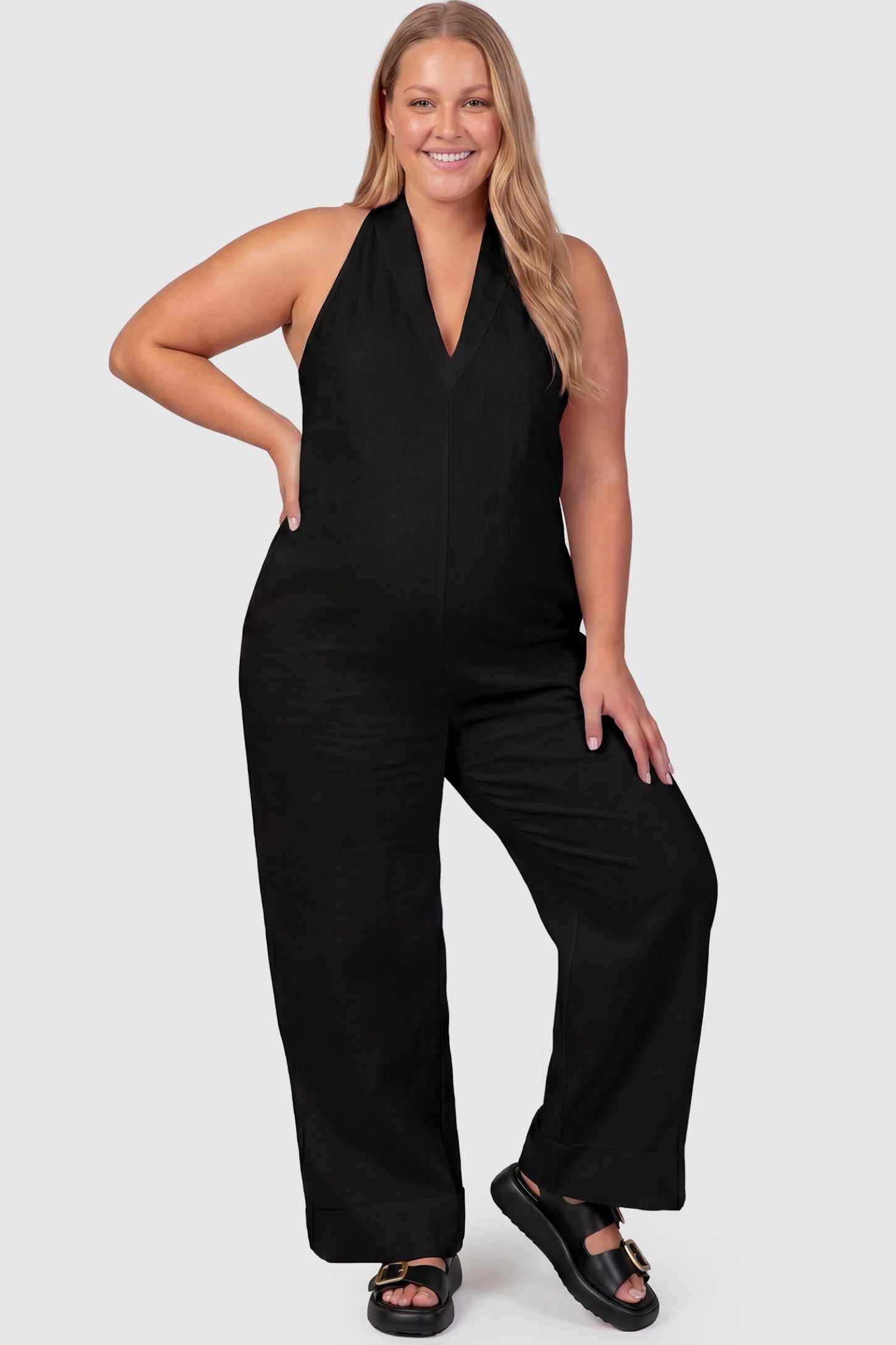 Halter Neck Wide-Leg Maternity Jumpsuit Halter neck wide-leg maternity jumpsuit in black with chic halter neckline, front view on plus-size model