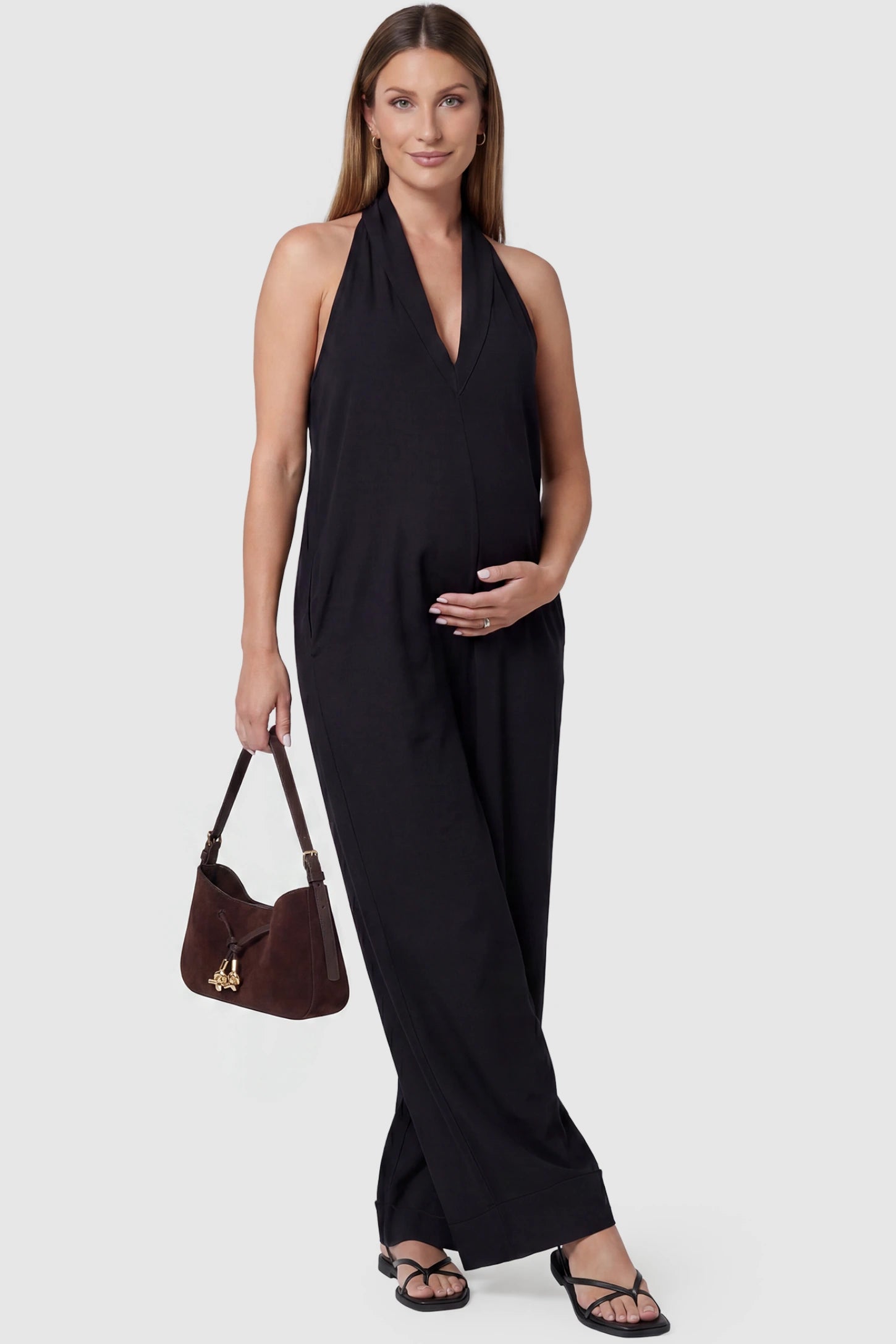 Halter Neck Wide-Leg Maternity Jumpsuit Halter neck wide-leg maternity jumpsuit in black with chic halter neckline, front view on pregnant model